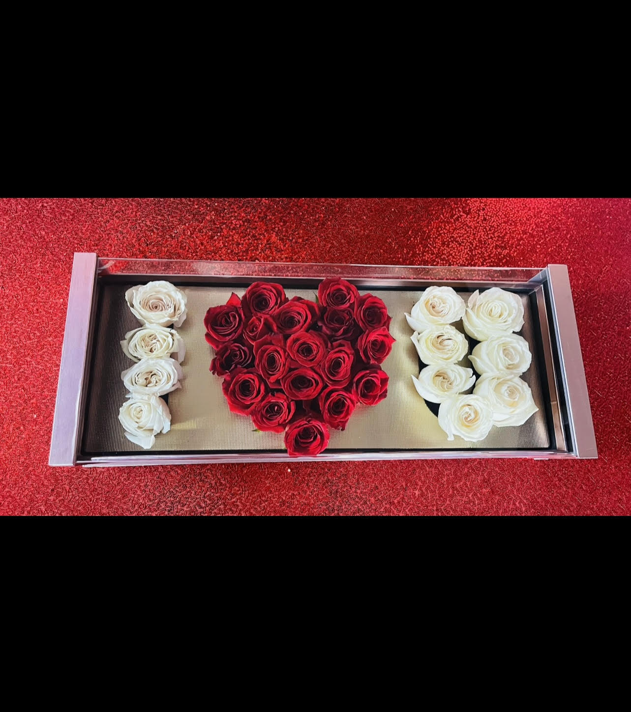 Box of Love by Flower Carriage - Declare your love with this magnificent " I Love You" Rose Box and let it take their breath away. A modern twist on your traditional rose boxes, this show-stopping arrangement can be proudly displayed with the acrylic case for an ultimate display. The I Love You Rose Box is an amazing celebratory gift for date night, an engagement, wedding, birthday, anniversary, Valentine's Day, or even as a just-because gift.   Approx. dimensions: W: 25" x 10" H: 5 1/2"   Around 30 roses *Customize to any color roses  (If you would like to change the rose color please leave it in the notes or call us, if not it will be ordered as pictured)