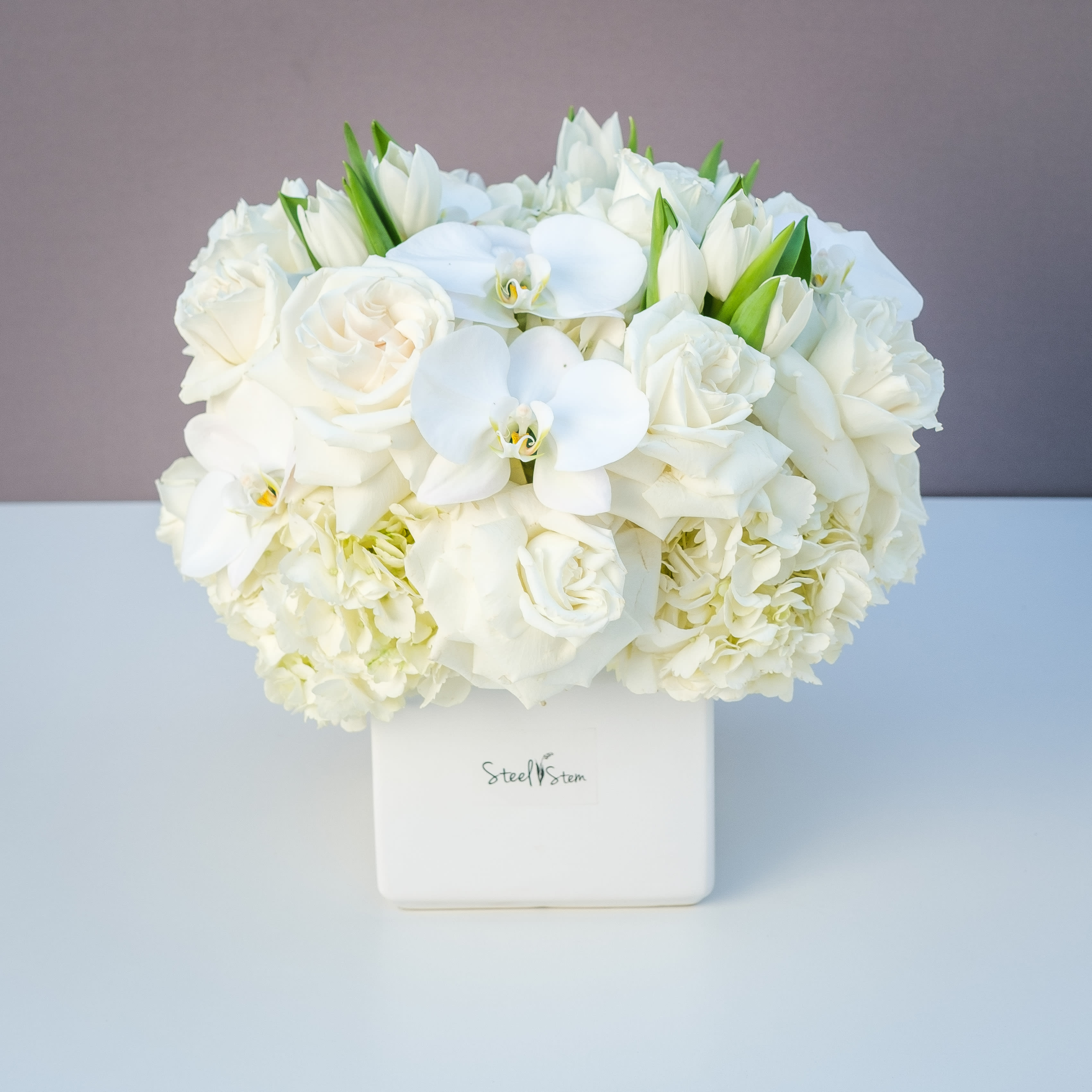 White Diamond - Luxury monochromatic white floral design  lush and full of premium white  hydrangea, orchid, tulips and white roses. Classic, elegant &amp; traditional all one one. 