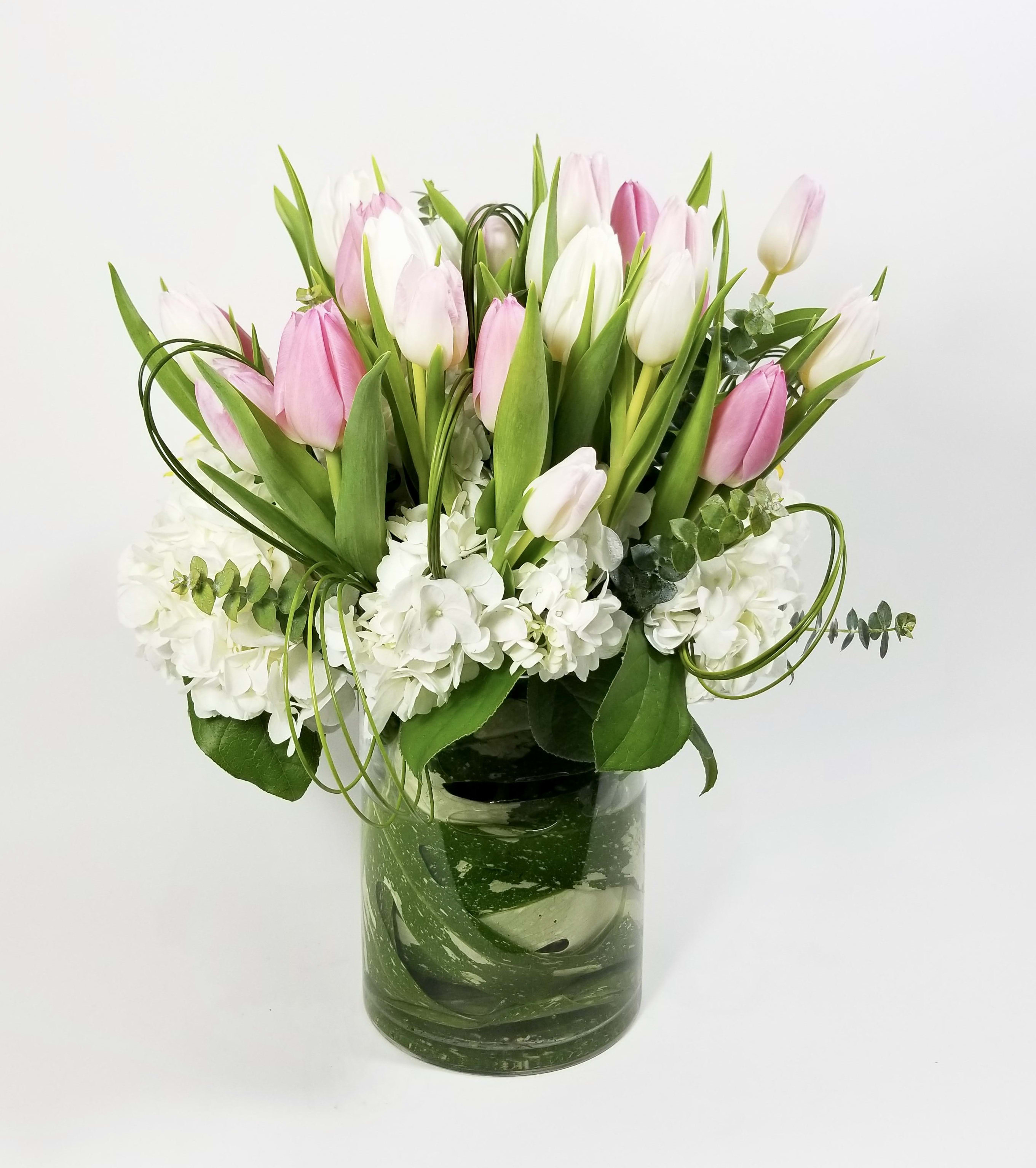 Dutch Blush - Arrangement of Fresh Cut Hydrangeas with a bouquet of colorful tulips, and exotic greenery.  Approximately 10" H by 8 W  There is a window of 24 hours to fulfill these order. 