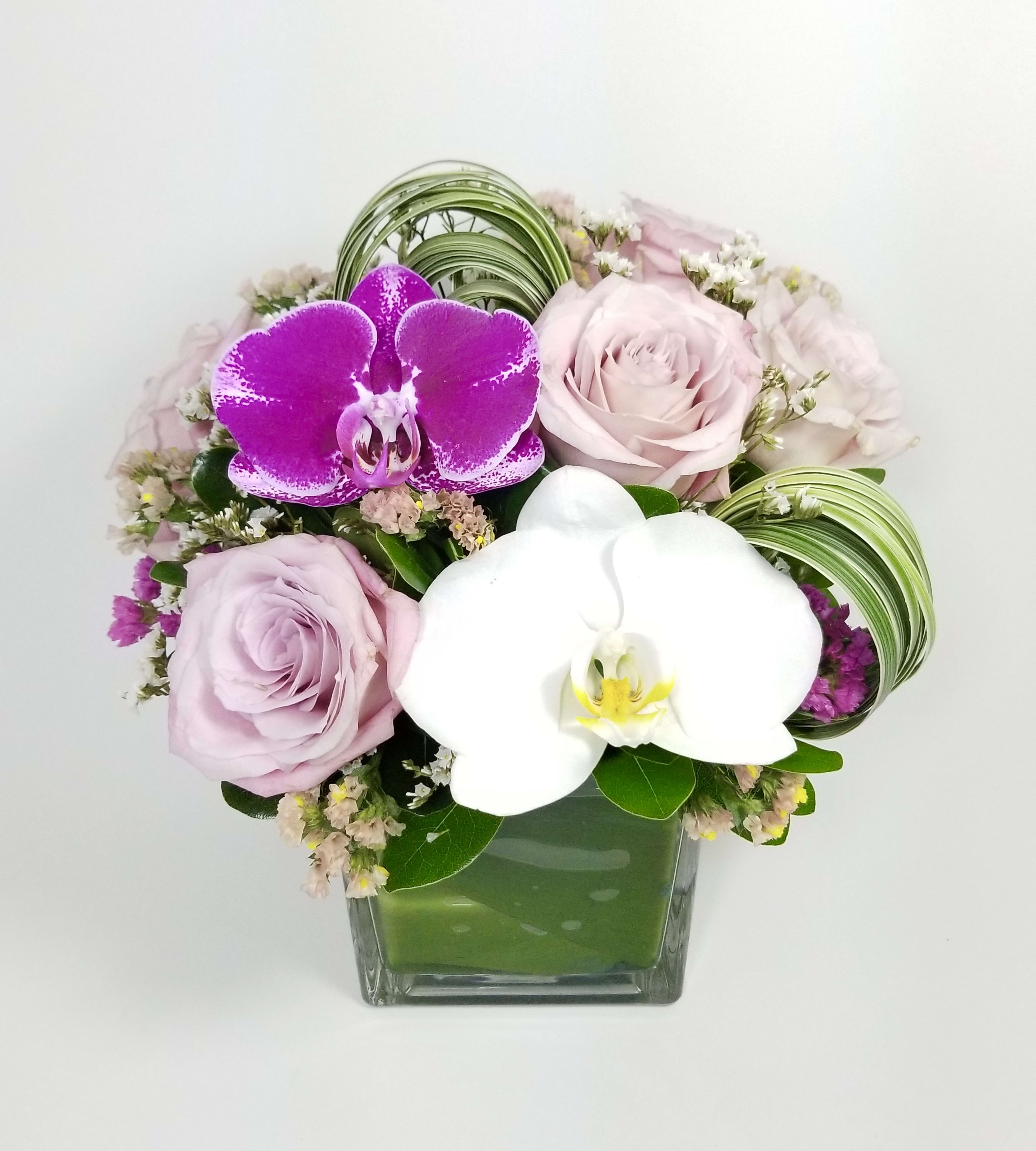 Hey Pretty  - Beautiful arrangement of premium pink roses, Statice, Phalaenopsis Orchids, Lily Grass, greenery and floral fillers.   Approximately 10" H by 10" W