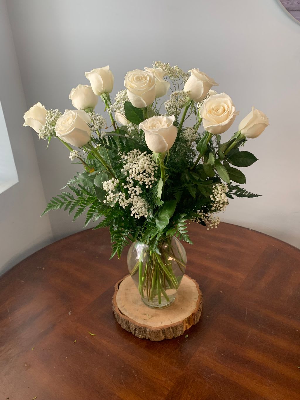 white roses - 12 white roses in a vase with filler and greens