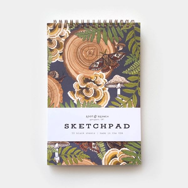 Mushroom Grove Sketchpad - Root &amp; Branch’s gold spiral-bound notebooks are everything you need in a sketchpad. Sturdy, elegant, portable, eco-conscious and made to last. Every bit of these sketchpad has been designed, sourced and assembled by hand in the USA. They make the perfect gift!  100% PCW recycled covers, including a sturdy chipboard backing 120 blank pages (60 sheets) printed on thick and smooth 30% PCW paper Gold spiral top binding allows the sketchpad to lay flat when opened Created with minimal packaging to eliminate waste Designed, sourced, and made by hand in the USA  Dimensions: 8.5 x 5.5 x 0.4 in (21.6 x 14 x 1 cm)
