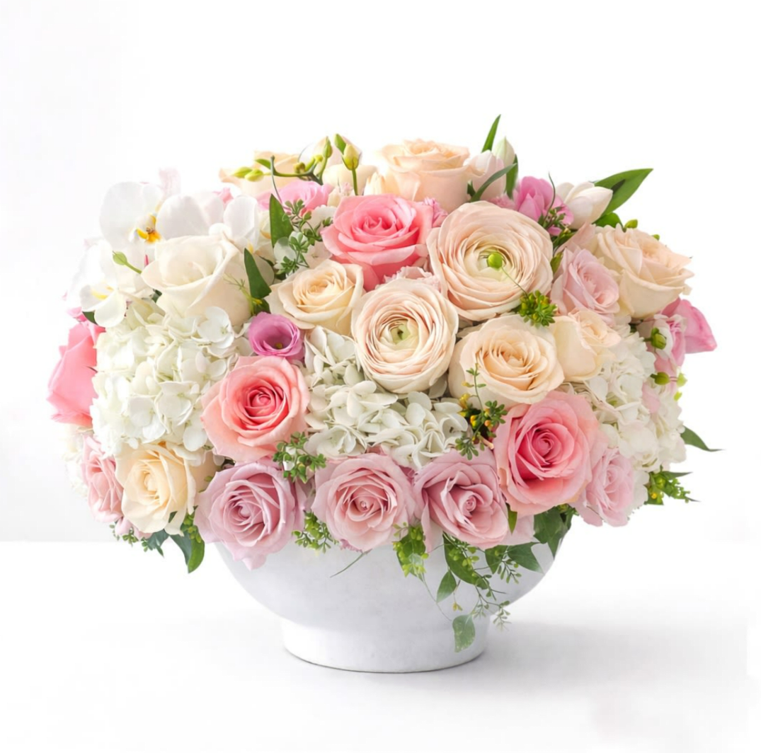 Velvet Blush - A soft, romantic daydream in bloom — this pastel Valentine’s arrangement blends gentle blush, airy pinks, and delicate tones into a lush design. Flowers featured include roses, Italian ranunculus, and hydrangeas.