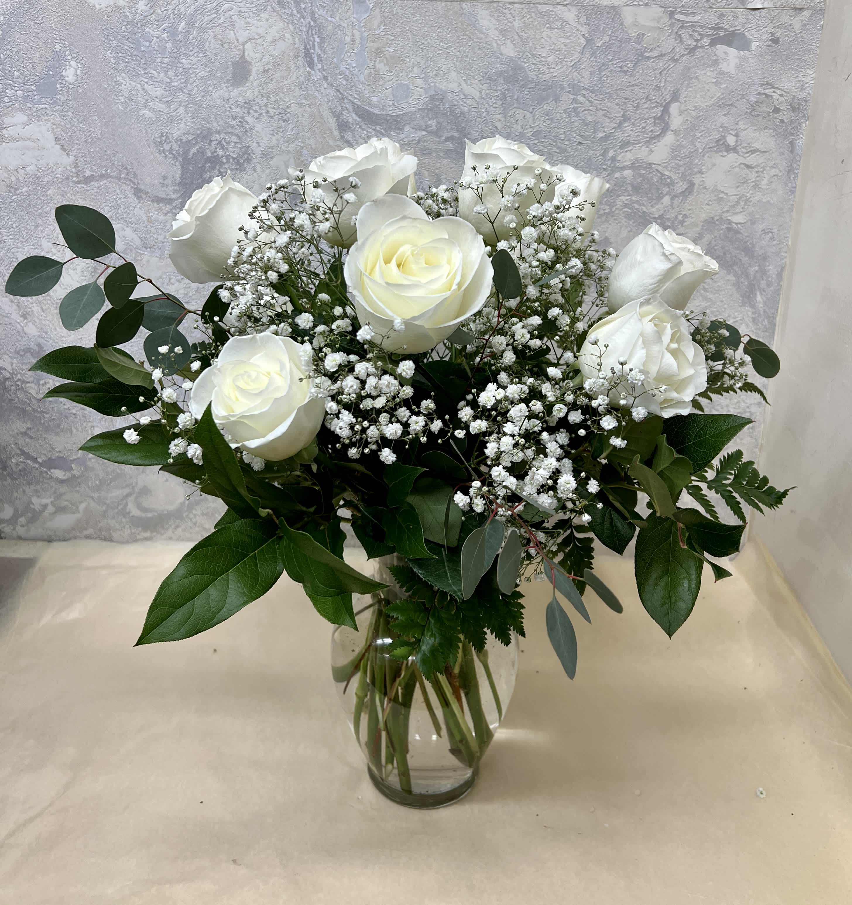 Classic White Roses - Dozen white roses arranged traditionally in a glass vase. A classic and beautiful gift.