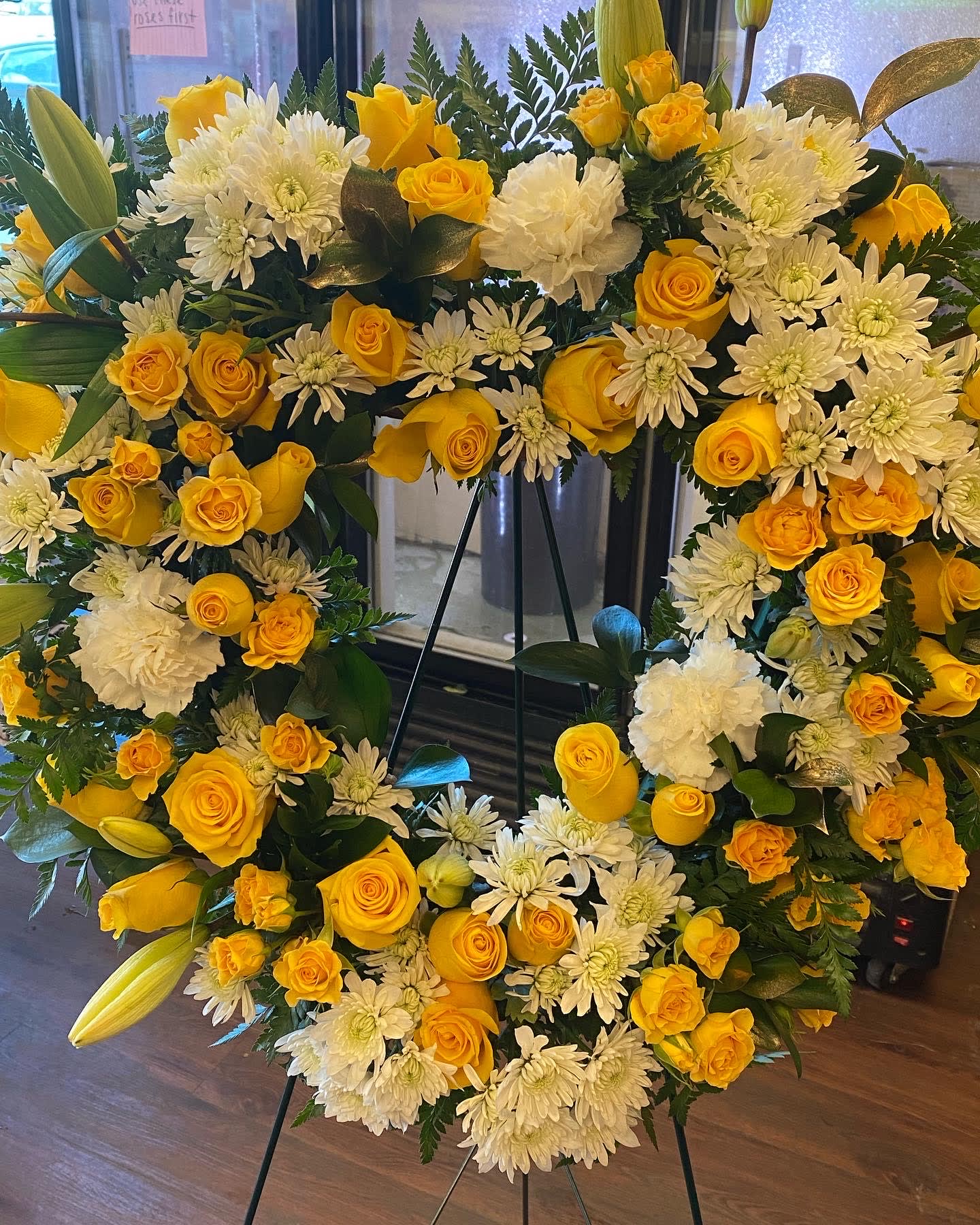 YELLOW AND WHITE HEART (DESIGNER CHOICE) - THIS HEART WITH YELLOW AND WHITE FLOWERS.  DESIGNER CHOICE WE WILL UTILIZE FLOWERS SUCH AS ROSES, CARNATIONS, CUSHION AND LILIES. Standard price is a 18 inch heart Deluxe price is a 24 inch heart Premium is a 24 inch heart with more Roses at least 46 roses and all the flowers stated above  