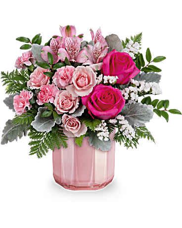 Blushing Gem Bouquet - This Valentine's Day arrangement showcases hot pink roses, pink spray roses, pink alstroemeria, miniature pink carnations, white sinuata statice, dusty miller, huckleberry, and leatherleaf fern. This beautifully pink bouquet is delivered in a Blushing Gem Vase. Approximately 15" W x 13 1/2" H