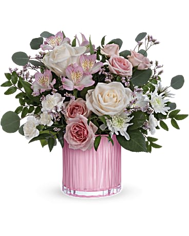 Teleflora's Posh Pink Bouquet - This Posh Pink Bouquet has creamy roses and delicate pink blooms which are the perfect surprise, especially when they're arranged in this sculpted, pearlescent glass vase. CrÃ¨me roses, pink spray roses, light pink alstroemeria, miniature white carnations, white cushion spray chrysanthemums and pink limonium are arranged with silver dollar eucalyptus and huckleberry. This gorgeous arrangement is delivered in a Rosy Pink vase.