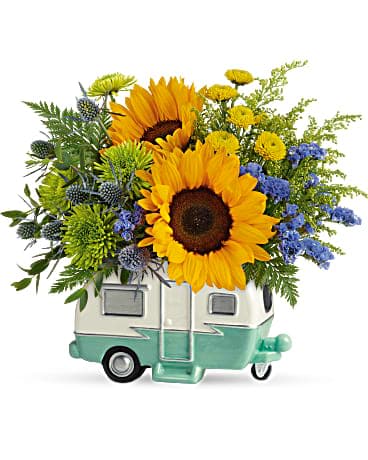 Teleflora's Retro Road Tripper Bouquet - It's impossible to be as cool as your dad, but this fun floral gift comes close! Roll into Father's Day with this retro ceramic camper, bursting with a colorful sunflower surprise he is sure to love. This retro-fabulous gift features yellow sunflowers, yellow button spray chrysanthemums, green cushion spray chrysanthemums, blue eryngium, blue sinuata statice, parvifolia eucalyptus, solidago, and leatherleaf fern. Delivered in a Retro Road Tripper Camper.