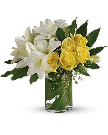 Escape with Me - Invite your special someone on an adventure of love with this fabulously free-form bouquet of lilies and roses in a chic glass cylinder vase. It will inspire you to discover each other all over again - without leaving home. The elegant bouquet includes yellow roses and white asiatic lilies accented with aralia leaves and seeded eucalyptus. Delivered in a glass cylinder vase.