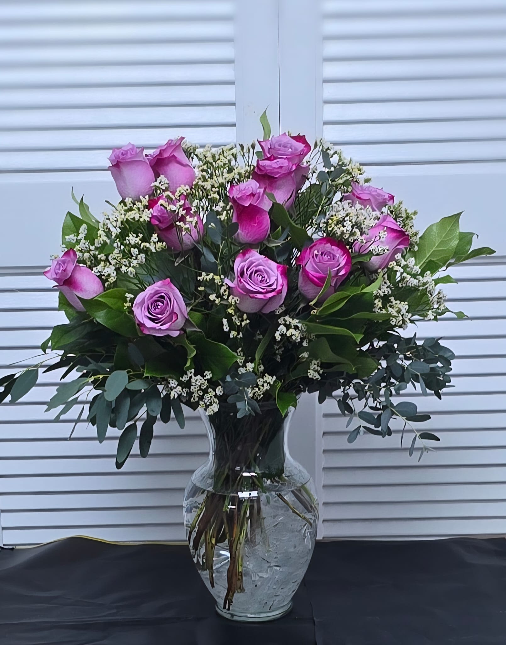 Lavender Rose Serenity - A timeless arrangement of soft lavender roses surrounded by delicate white baby’s breath and lush eucalyptus greenery. Elegant, romantic, and calming, this bouquet is perfect for expressing love, appreciation, or heartfelt sympathy with a graceful touch.