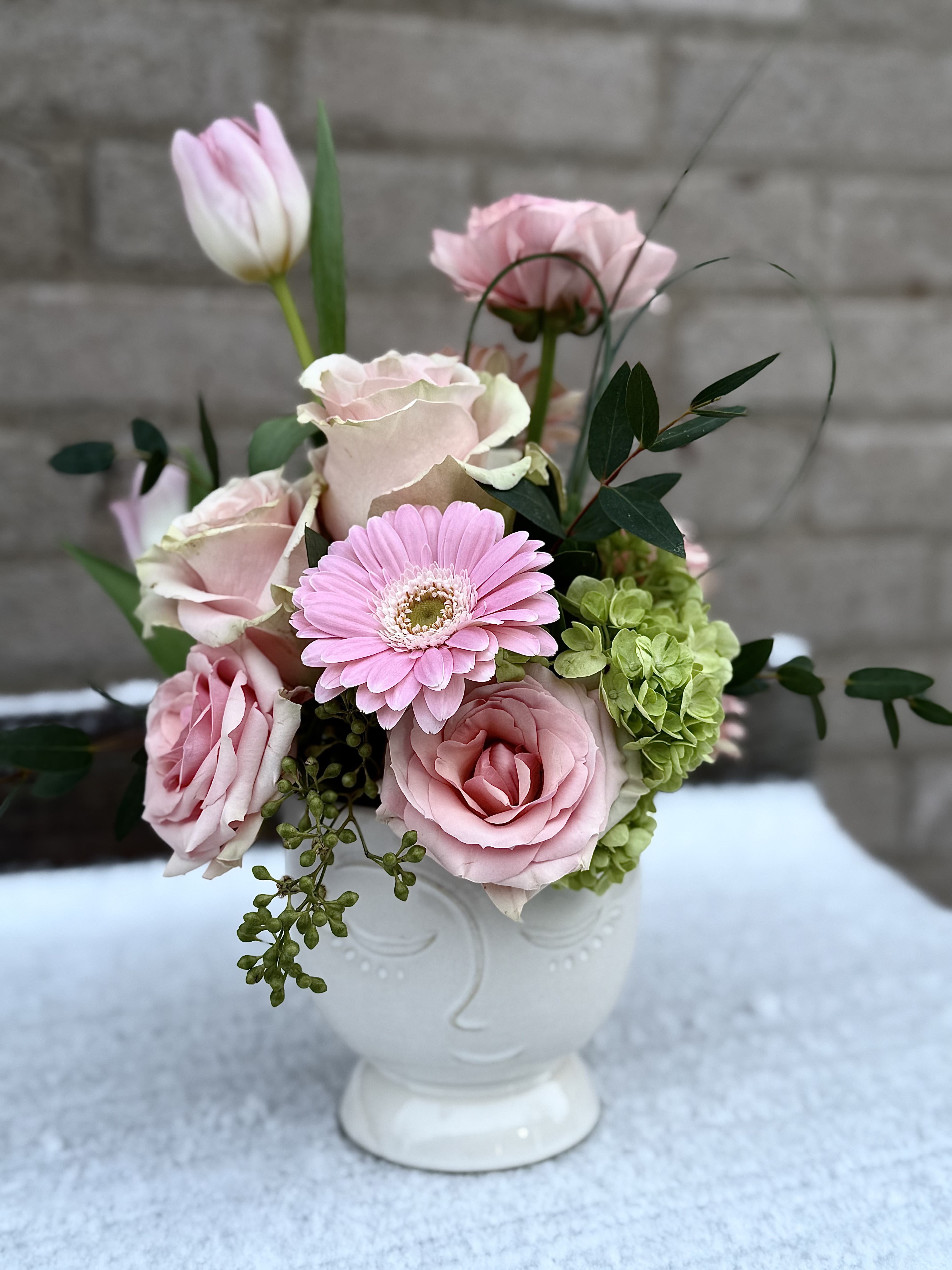 Pink Passion - A fun, shades of pink arrangement for the special person in your life, we have a combination of blooms in shades of pink, the vase has a face on it and can be used again especially as a plant container.