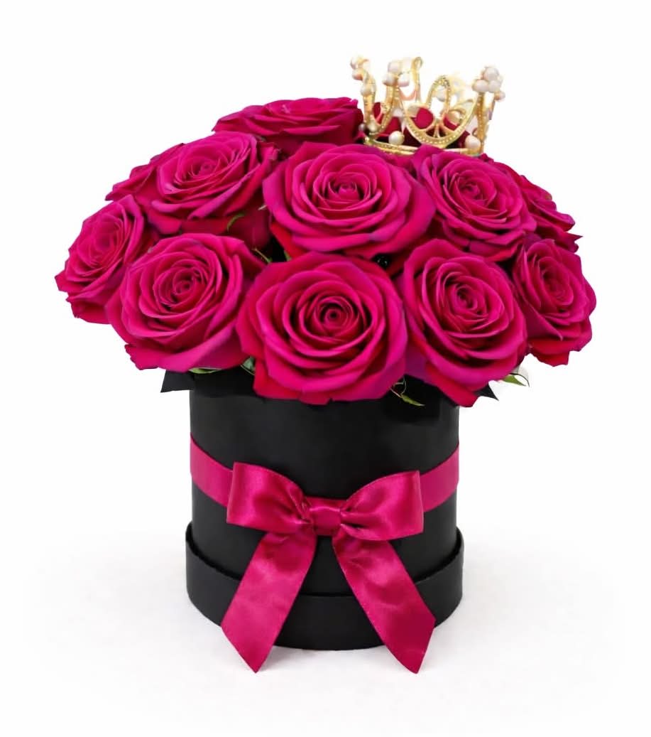 Queen of Roses - Hot Pink - A true statement of elegance and power. This stunning arrangement features vibrant fuchsia roses, beautifully styled in a sleek black hat box and finished with a satin bow and a delicate crown. Designed for queens, this piece is perfect for Valentine’s Day, anniversaries, birthdays, or any moment that deserves to feel royal.