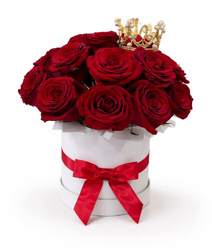 Queen of Roses - Red - A regal expression of love and elegance. This stunning arrangement features lush red roses beautifully arranged in a sleek white hat box, finished with a satin ribbon and crowned with a delicate gold accent. Designed to make a statement, this piece is perfect for Valentine’s Day, anniversaries, or celebrating someone truly special.