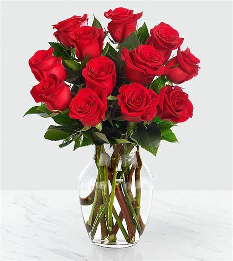 Red Roses 12ct - This all-red flower arrangement is hand-arranged with 12 long stem pink roses, a wonderful way of letting someone in your life know they are important to you on this special day. These red roses are delivered in a clear vase.