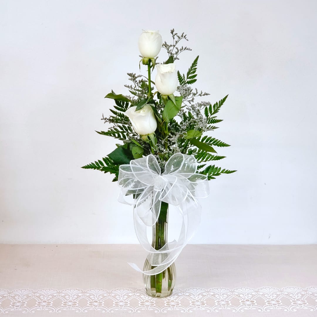 Quiet Beauty - Pure beautiful... three long stem white roses in a bud vase, with fresh greens and filler flower.