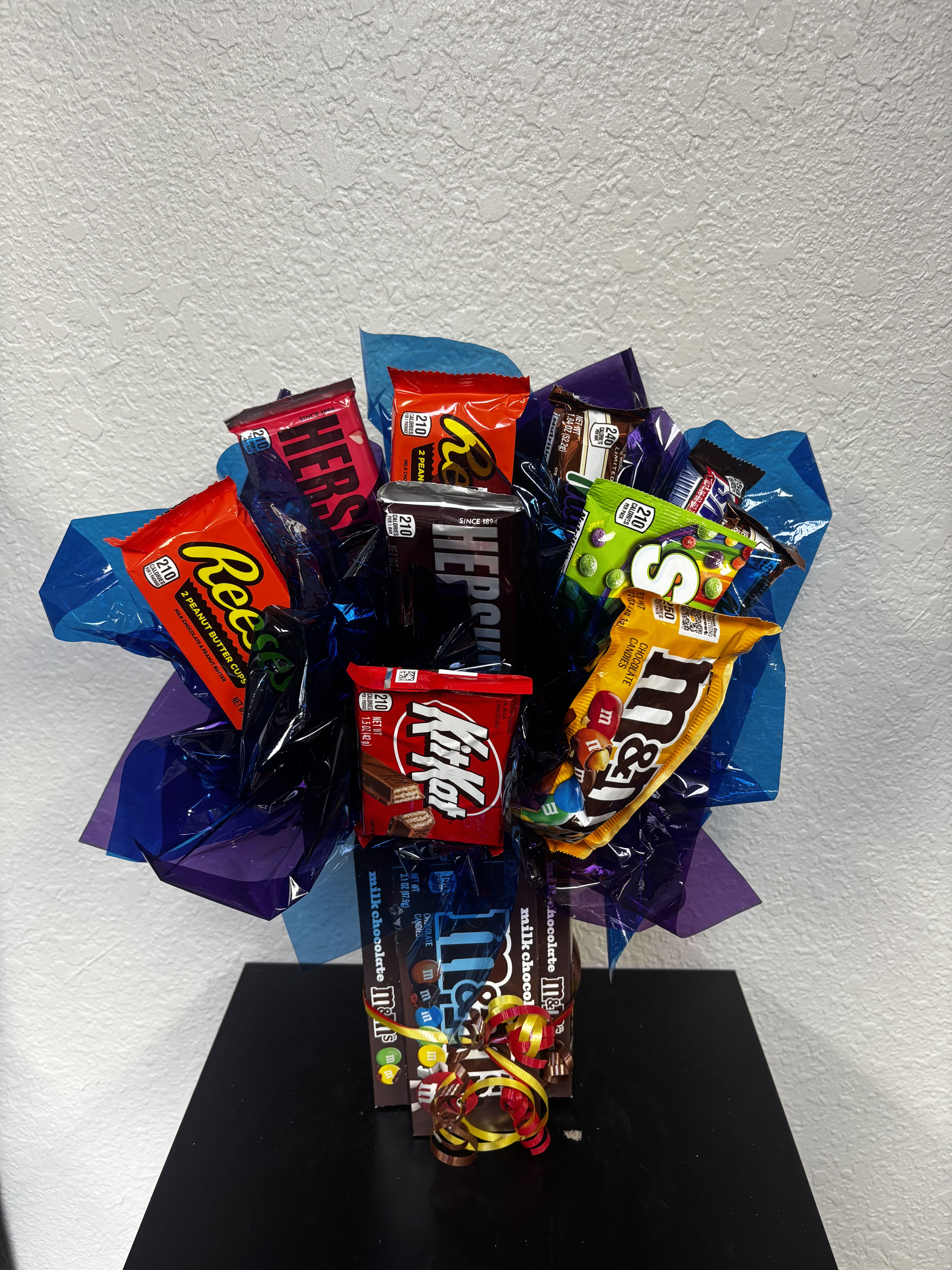 M &amp; M Candy Bouquet / plain or peanut - A fun and delicious twist on flowers! This eye-catching candy bouquet is packed with a variety of favorite sweets and chocolate bars, beautifully arranged in vibrant wrapping and finished with a festive bow. Perfect for birthdays, thank-yous, get well, congratulations, or just because—this bouquet is guaranteed to make anyone smile! Includes an assortment of popular candy bars (may vary based on availability).