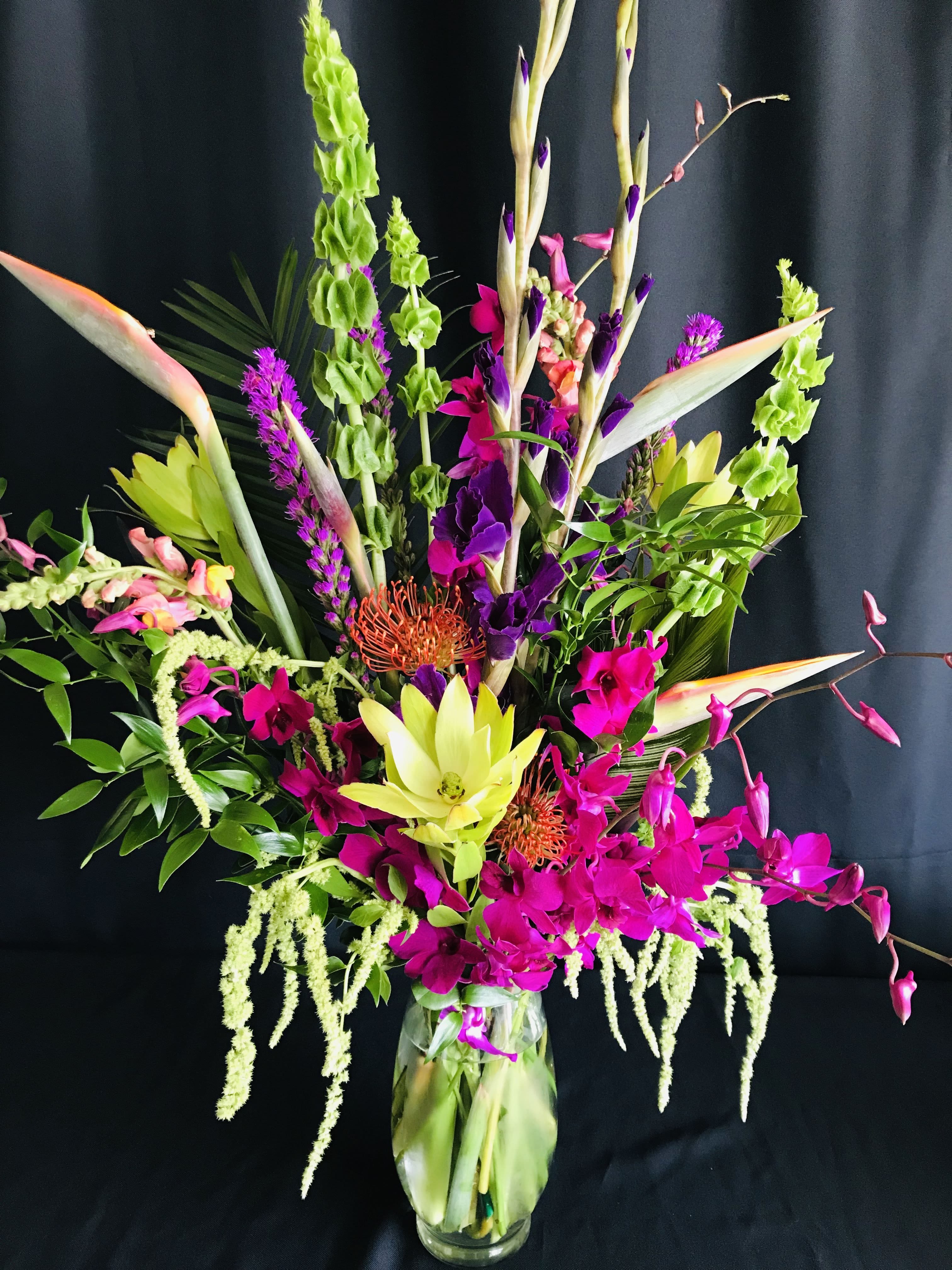Vivid Bird of Paradise Orchid Exotics - Stunning and Tall, this exotic arrangement is full of exquisite flowers you rarely see in flower shops. We get them from all around the globe. Order a minimum of a week in advance for closest match. We must substiute with other exotic flowers when global shipment delays occur or for last minute orders. We will fill to dollar value.