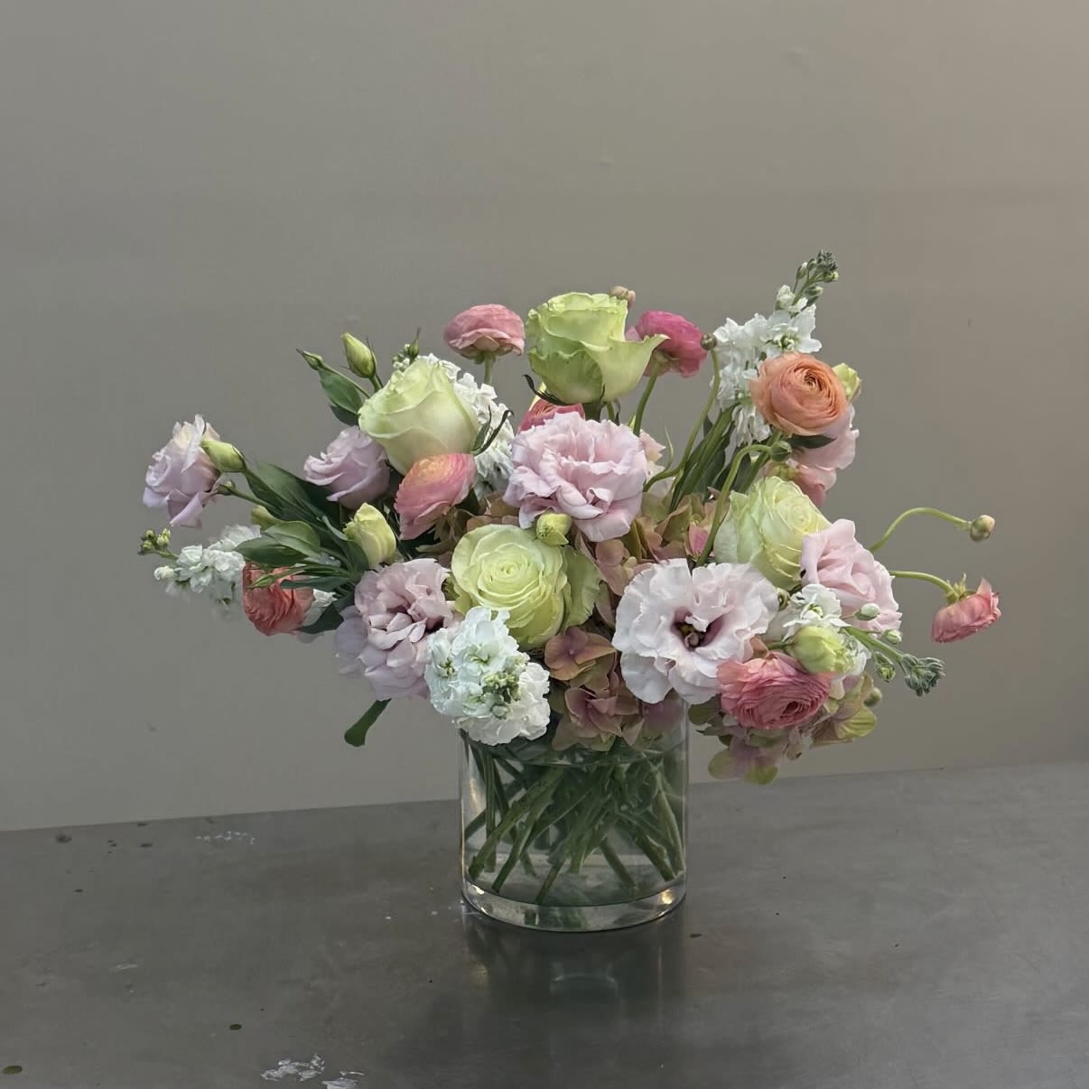 Cotton Candy Dream - Pastel floral created with roses, lisianthus, ranunculus, stock, and hydrangeas in shades of pinks greens and whites.