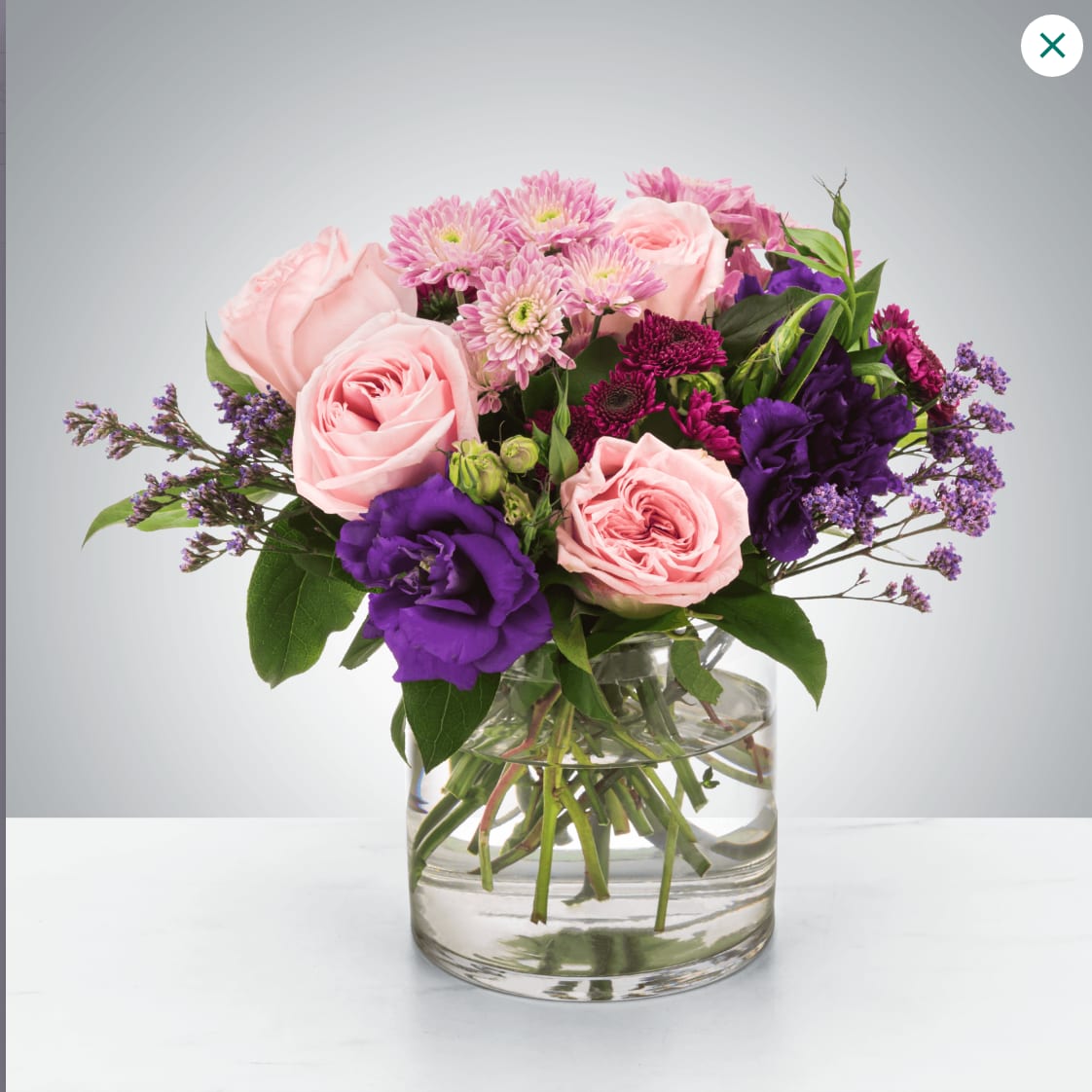 Coming Home  - A selection of pink and purple flowers come together in an eye-pleasing arrangement. This arrangement makes a great gift for Mother's Day, Women's Day, or as a thinking of you present.  Approximate Dimensions: 10''D x 10''H