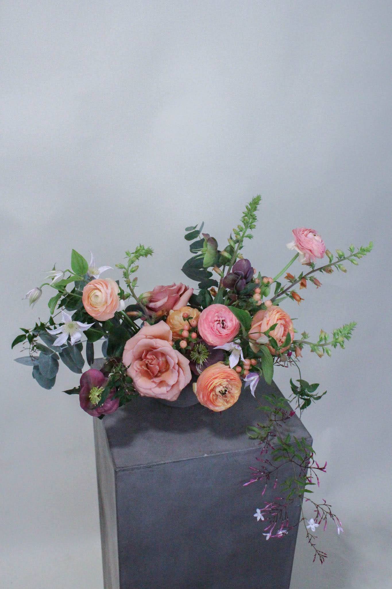 Rasberry and Peach Centerpiece - Lush, low and sprawling centerpiece great for elevating any table. Order multiples for King and Queen's tables or to fill many round tables at your event.  *Images are a representation of our design style. Each arrangement is made to order and flower selection will vary due to product availability the week of your order.