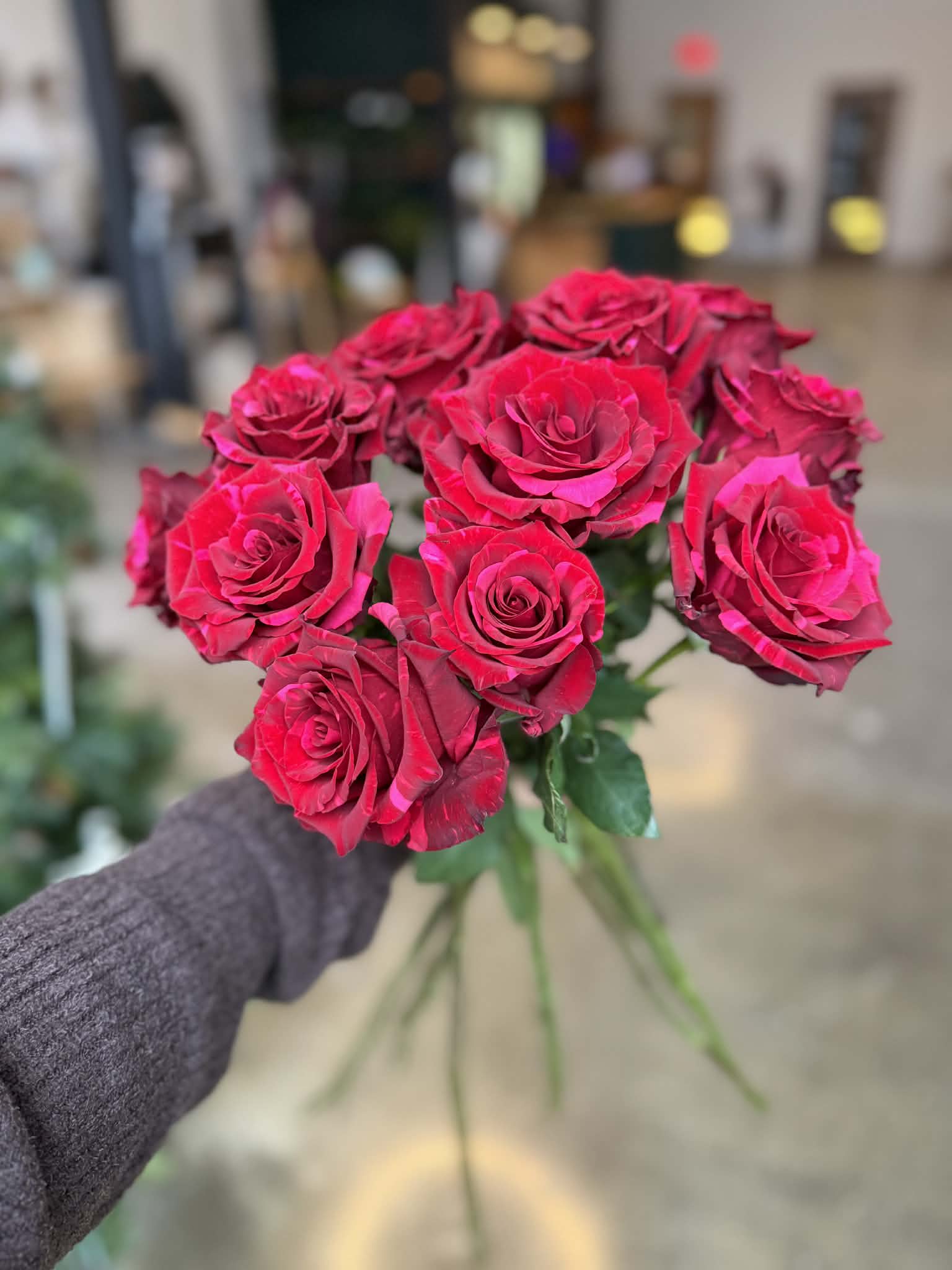 Red Panther Roses in a Vase - Bold, romantic, and timeless, our Red Panther Roses offer a refined take on the classic red rose. Known for their rich red hue and full, velvety petals, Panther roses are a premium variety chosen for their beauty, consistency, and striking presence.  Designed in a glass vase with fresh seasonal greens and subtle filler, this arrangement feels elegant and intentional — a beautiful expression of love for Valentine’s Day or any meaningful romantic occasion.