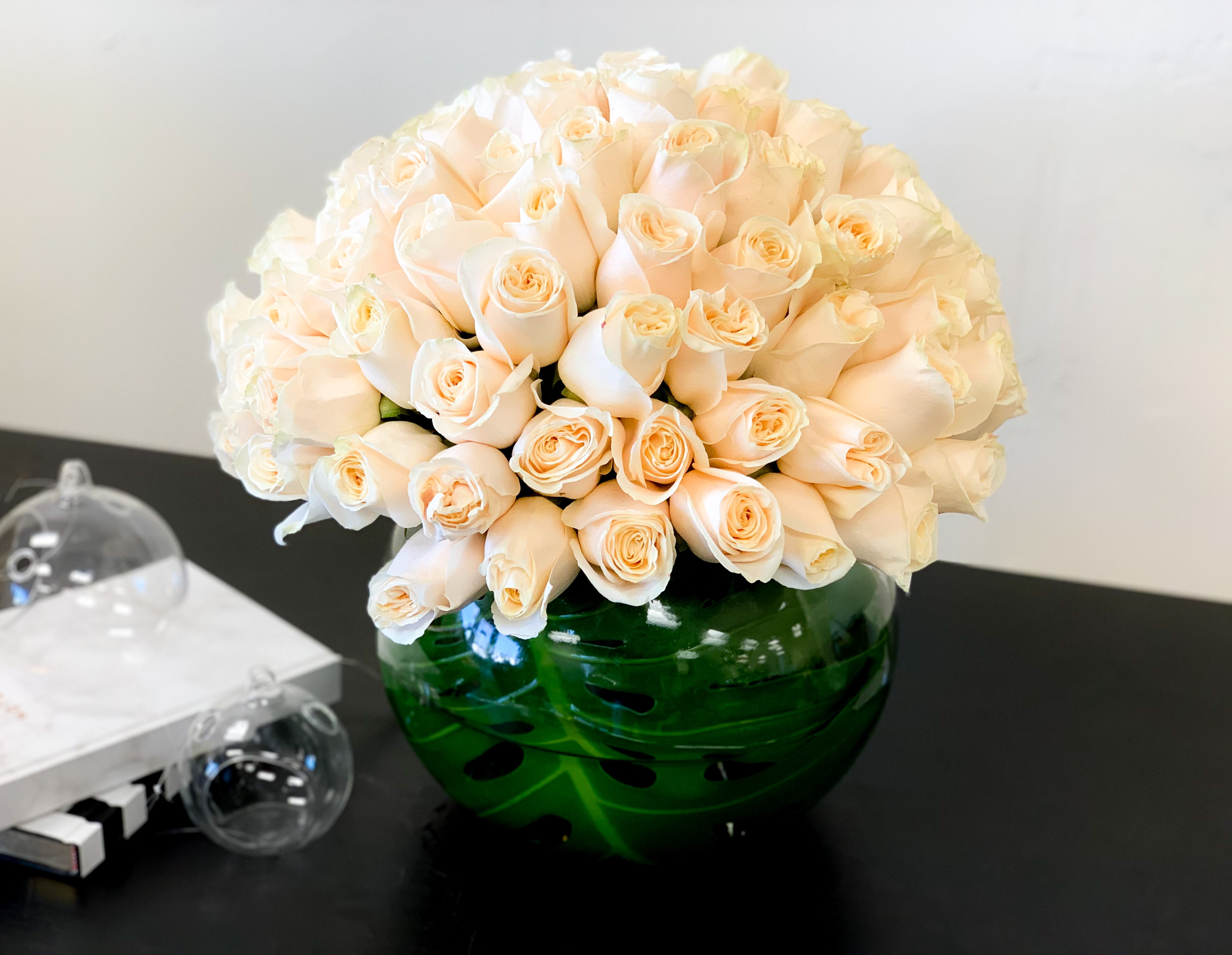 100 White Roses Arrangement in Vase  - Luxurious design with 100 premium white roses in fishbowl vase. 