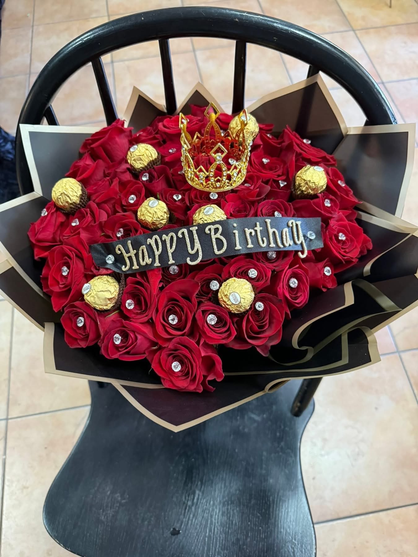 Ramo buchon  ferrero - 50 red rosas with 12 ferreros chocolate  and little crown and black paper and including banner with you own message