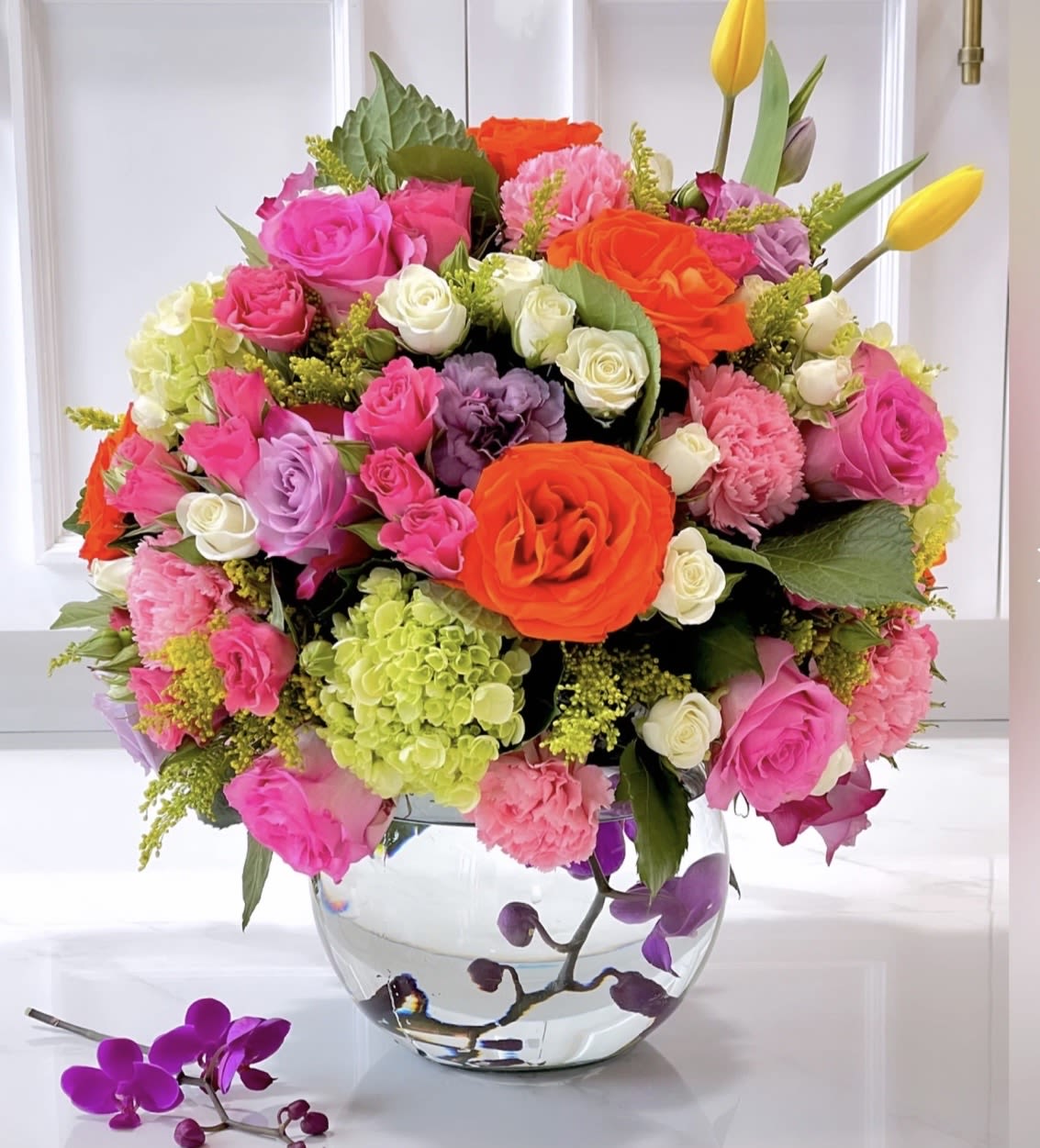 SUMMER LOVE  - Glass bowl with submerged orchids and a full twist of summer bright blooms.  "NOTICE" We are dedicated to delivering your emotional sentiments with the utmost care, ensuring that each arrangement is fresh, beautiful, and arrives on time. Due to the natural variability of flowers, as well as seasonal and regional availability, substitutions may occasionally be necessary. Rest assured, any substitutions will be of equal or greater value, and we will make every effort to preserve the overall design, including the shape, size, style, and color combinations of the arrangement. In the case of single-variety arrangements, the specific variety will take precedence over color to maintain the intended look and feel. Thank you in advance for understanding that flowers are a natural product and may vary slightly in appearance