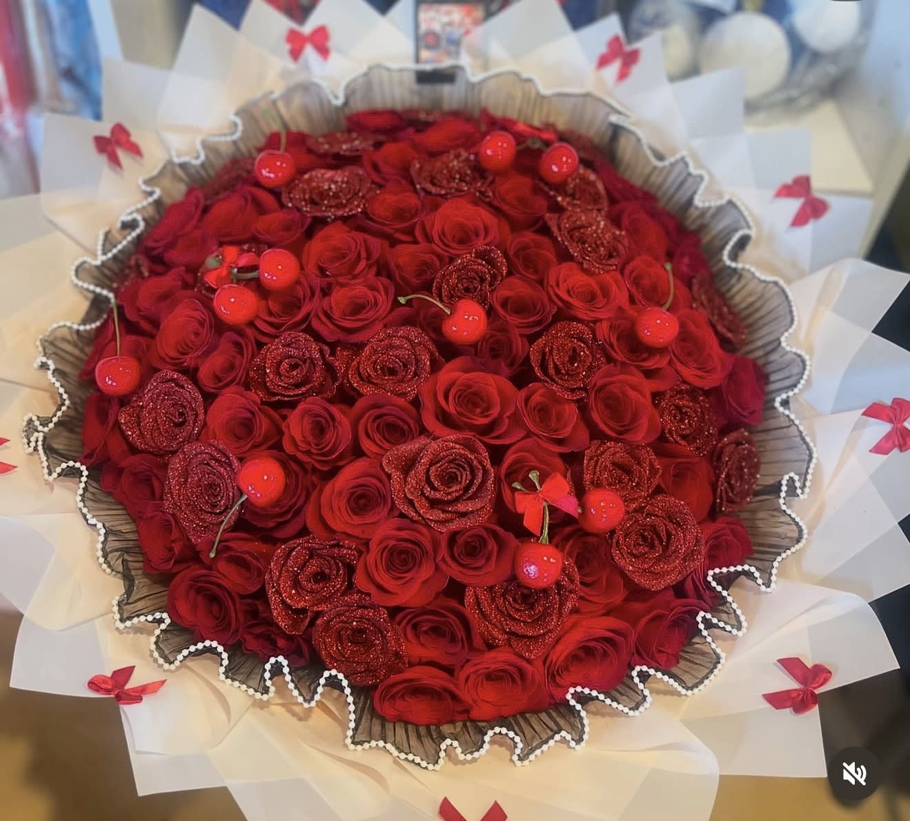 CHERRY LOVE ROSE BOUQUET  - This is all you need to make that special person fall in love. Surprise she or he with an elegant all red roses bouquet. Our hand-tied bouquets are delicately arranged combining pure Ecuadorian roses. Bouquet includes; 75 Red and red glitter roses  pearl mesh  White wrapping paper top7with cute red bows and cherry.     “NOTICE”  We are dedicated to delivering your emotional sentiments with the utmost care, ensuring that each arrangement is fresh, beautiful, and arrives on time. Due to the natural variability of flowers, as well as seasonal and regional availability, substitutions may occasionally be necessary. Rest assured, any substitutions will be of equal or greater value, and we will make every effort to preserve the overall design, including the shape, size, style, and color combinations of the arrangement. In the case of single-variety arrangements, the specific variety will take precedence over color to maintain the intended look and feel. Thank you in advance for understanding that flowers are a natural product and may vary slightly in appearance.