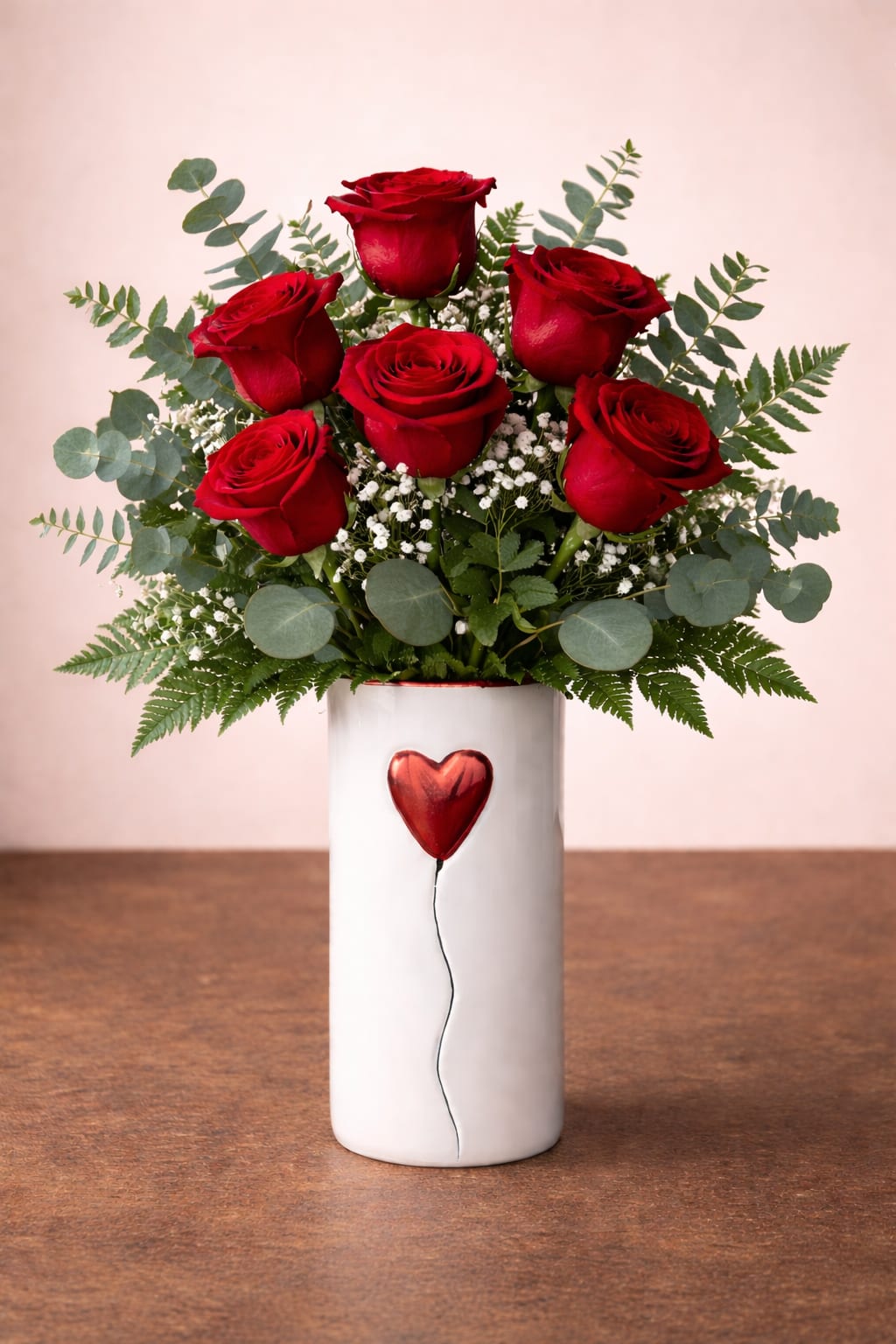 You Have My Heart - 6 gorgeous red roses, presented in a keepsake heart vase. Definitely a perfect fit for the traditional Valentine's day celebration.  Vase is approximately 6 inches tall, with over all arrangement approximately 16 inches tall.