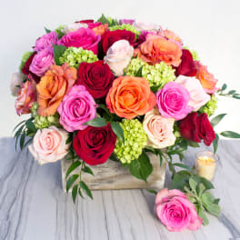 Rainbow of Roses (BR) - Experience a burst of vibrant colors with our exquisite arrangement of 24 assorted color roses and mini green hydrangea, elegantly presented in a square wooden box.