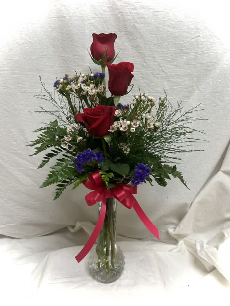 Triple Red Rose Budvase - Three roses in a budvase with selected greenery and fillers witha. bow.  