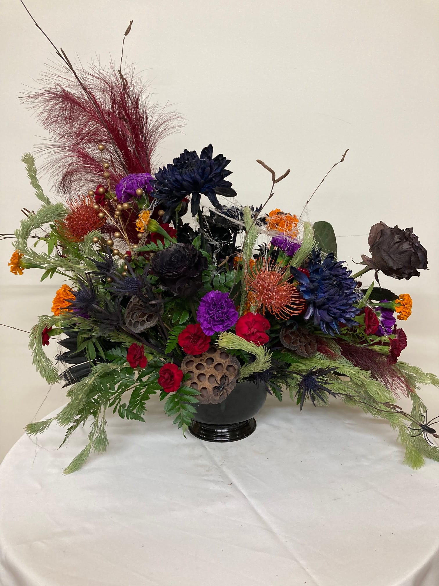 Happy Halloween - Give a creepy. crawly, spooky arrangements mad with mums, carnations, roses, marigolds, berries, seed pods, weeping willow, protea, and critters.