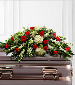 The FTD® Sincerity™ Casket Spray - The FTD® Sincerity™ Casket Spray is a wondrous presentation of fresh color and beauty. Rich red roses and carnations are eye-catching and elegant in an arrangement of white hydrangea, larkspur, snapdragons, Queen Anne's Lace and assorted lush greens to create a lovely display meant to bedeck the top of their casket, bringing comfort and peace to those grieving the loss of the departed. Approximately 30"H x 48"W. Your purchase includes a complimentary personalized gift message.