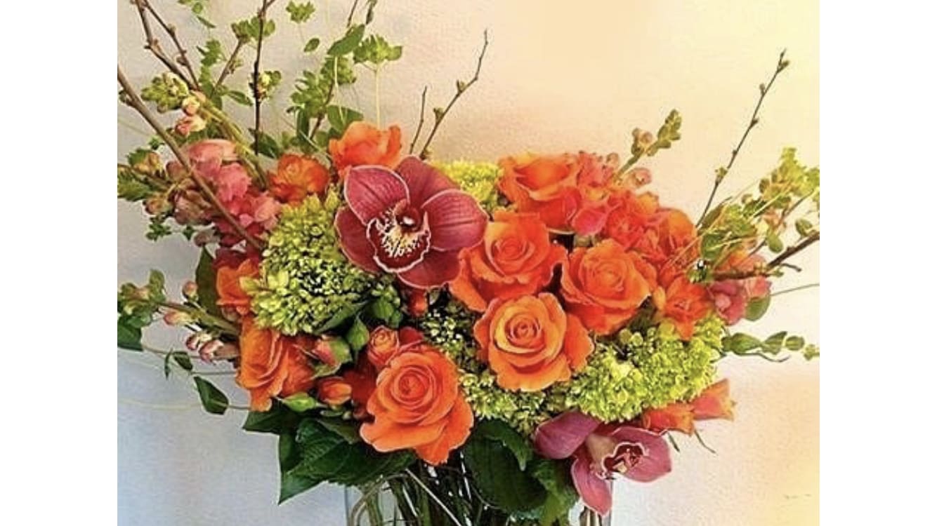 Orange Splash - Send a refreshing splash of orange roses with orchids.