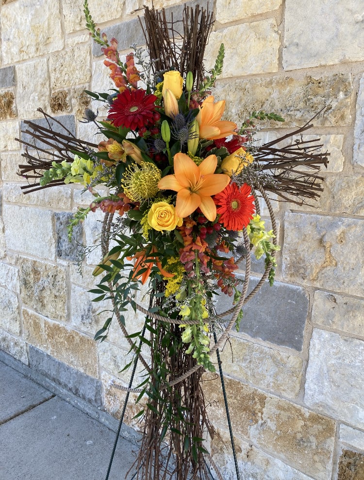 Grapevine Cross Easel with Autumnal Swath - Yellows, Oranges, and Burgundy blooms decorate the cross-shaped grapevines