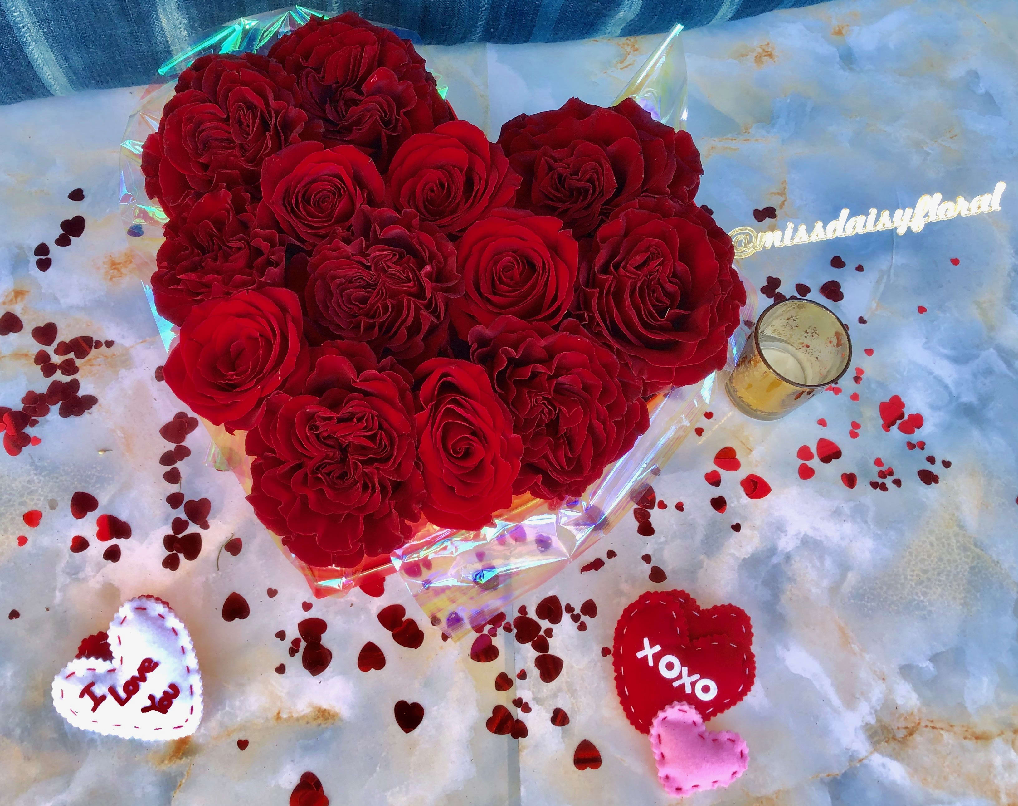 Baby Love Red - Small Bloombox - Our "Baby Love" Small Bloombox is created with 12-14 fresh red roses and red garden roses styled in our festive heart box. This all red rose bloombox for Valentine's Day is hand crafted in Las Vegas by our all-women design team. Using the freshest blooms from around the world such as roses overflow these sweet boxes. *Please note, these will be made with ALL red roses, please inquiry for substitution availability! 