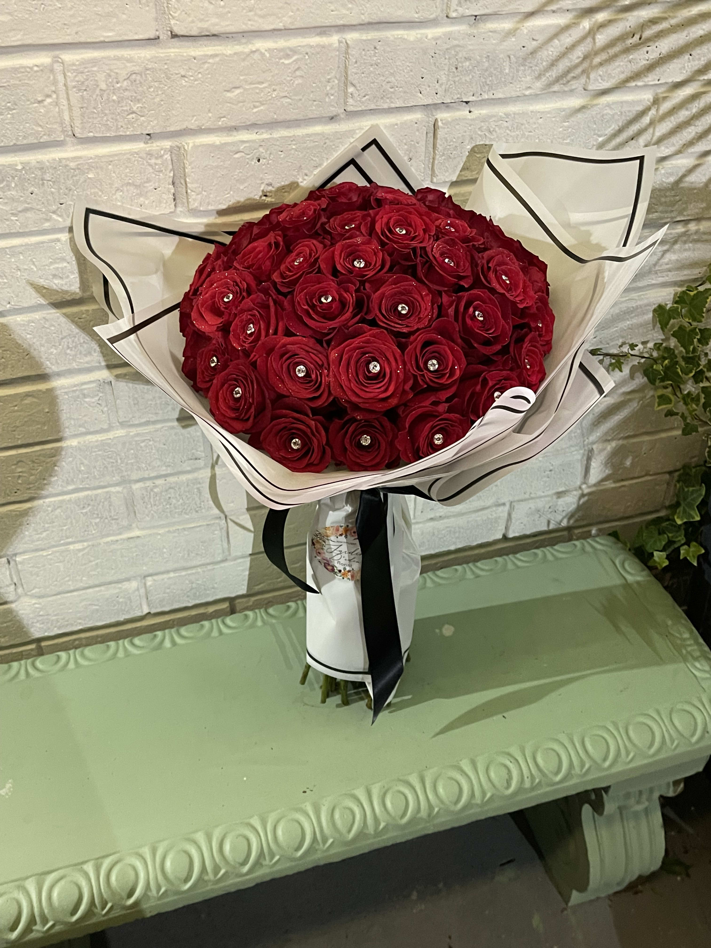  30 Rose Ramo Bouchon  - This beautiful bouquet is hand wrapped in beautiful Korean wrap paper. We can customize in any color roses if available. We have different color paper to match roses and this is paired with diamonds. 