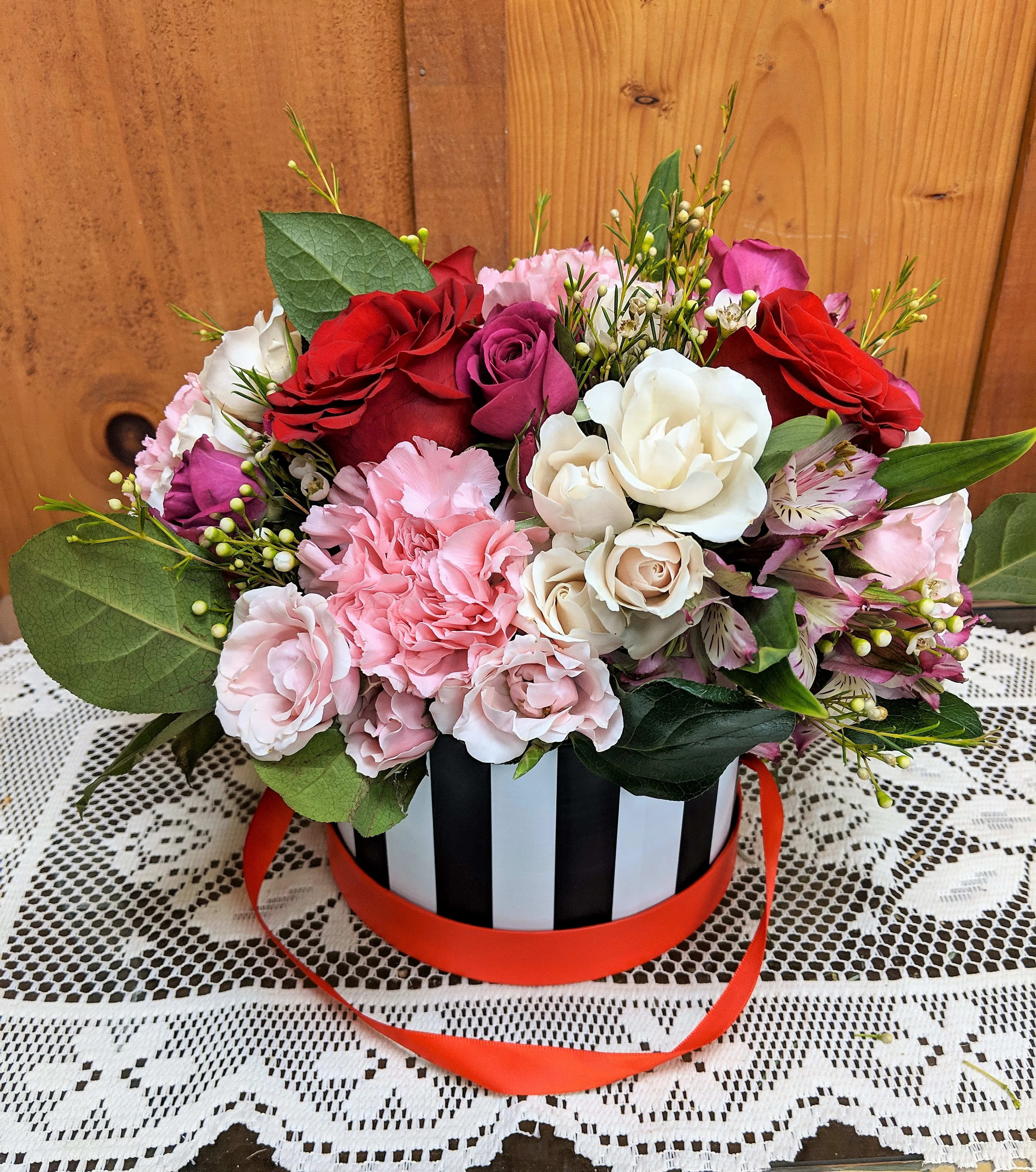 Love Is Blooming Hat Box - A unique spin on the classic Valentine's Day arrangement. Fresh flowers beautifully arranged in a keepsake hat box. . 