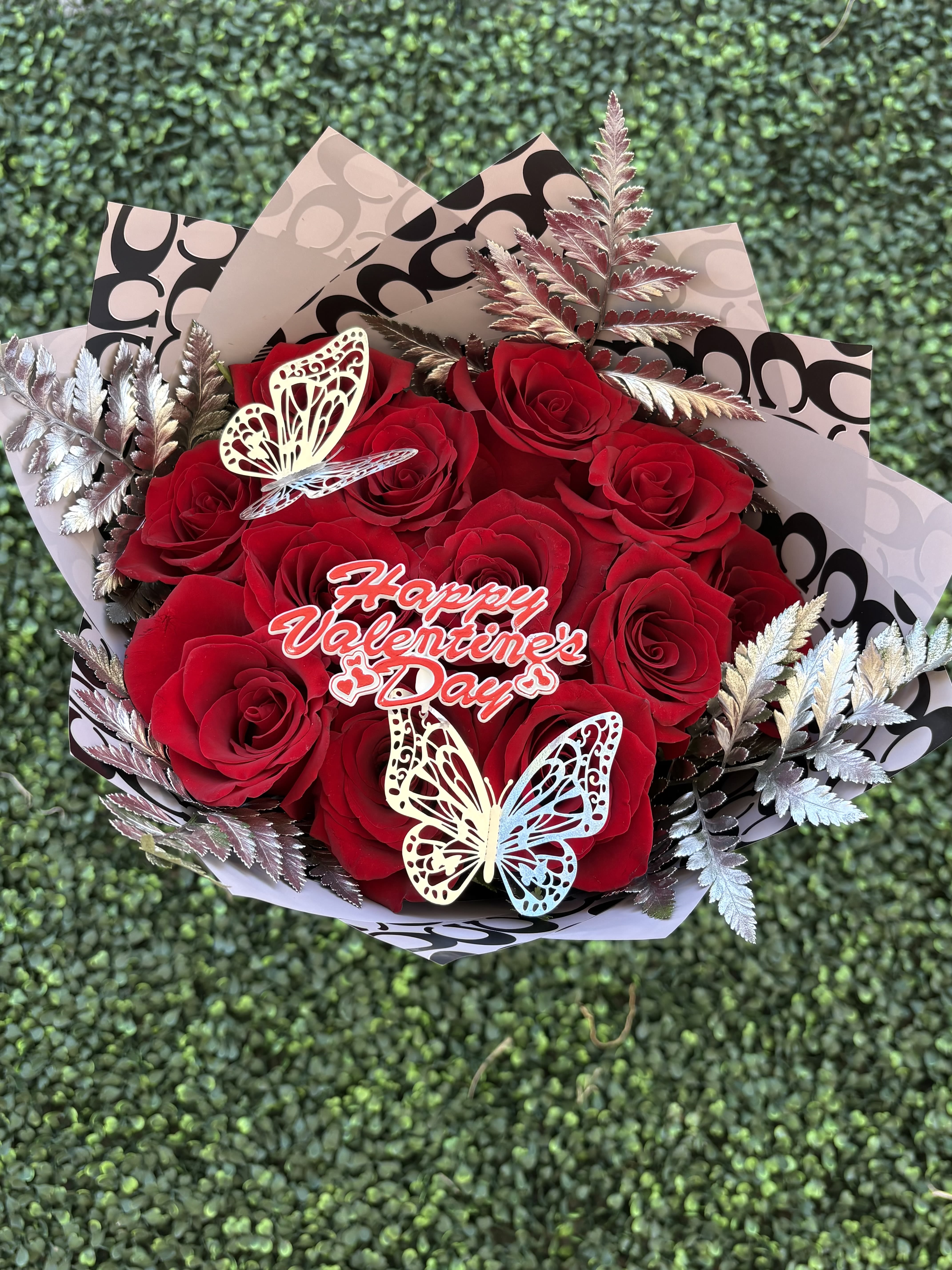 Silver CC bouquet  - Dozen red roses with silver greens is a best way to express your love this holiday season 