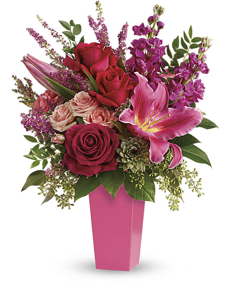 Forever Fuchsia Bouquet - Pretty in pink! A surprise they'll remember forever this fantasy of fuchsia lilies roses and carnations is artistically arranged in a sleek contemporary vase. This stunning bouquet features pink oriental lilies hot pink roses pink carnations fuchsia stock light pink spray roses pink heather lemon leaf huckleberry seeded eucalyptus and a small green potted echeveria succulent. Delivered in a raspberry tapered vase.