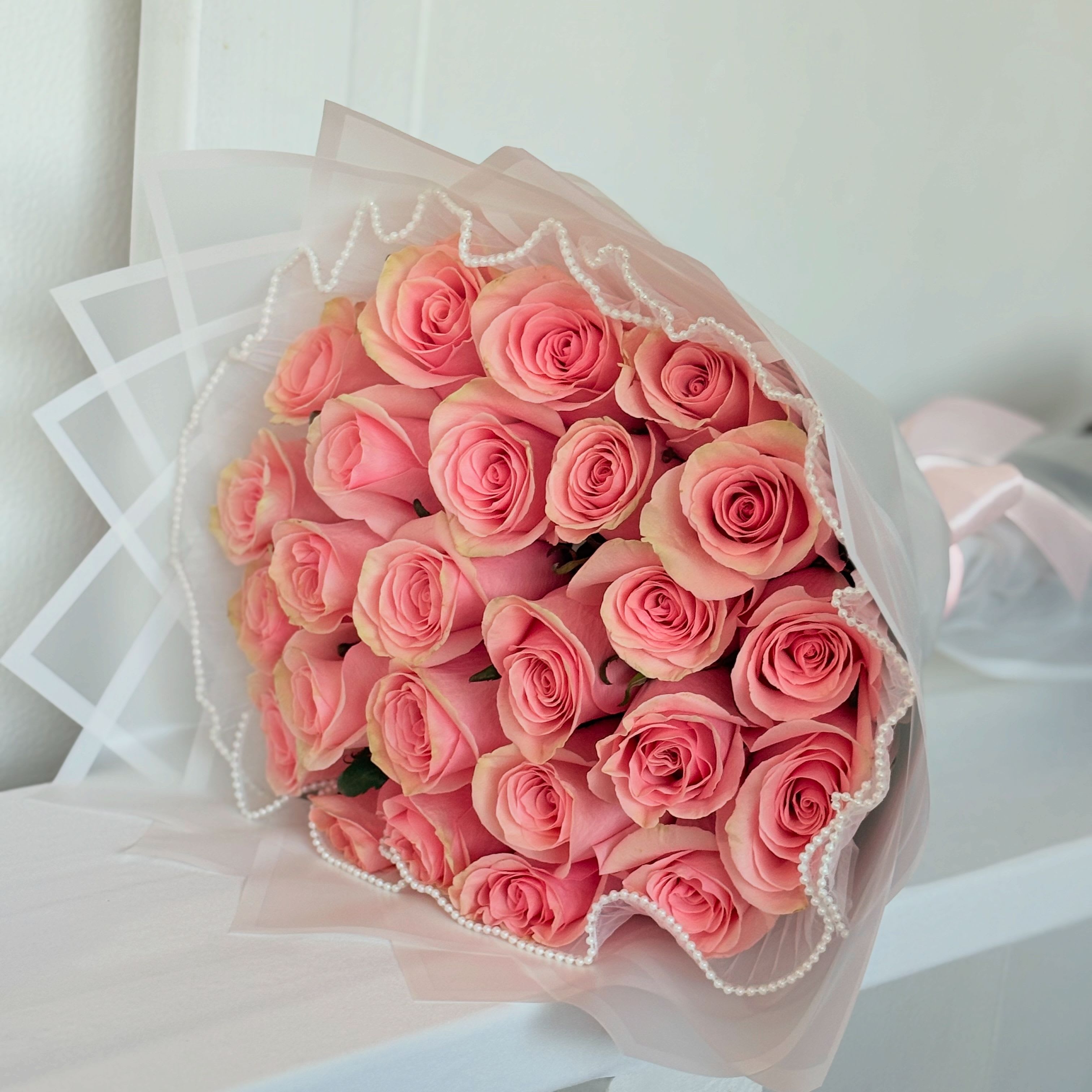 Two Dozen Pink Roses - 24 pink roses long-stem roses, wrapped with waterproof wrap. Wrap color may vary due to availability. 