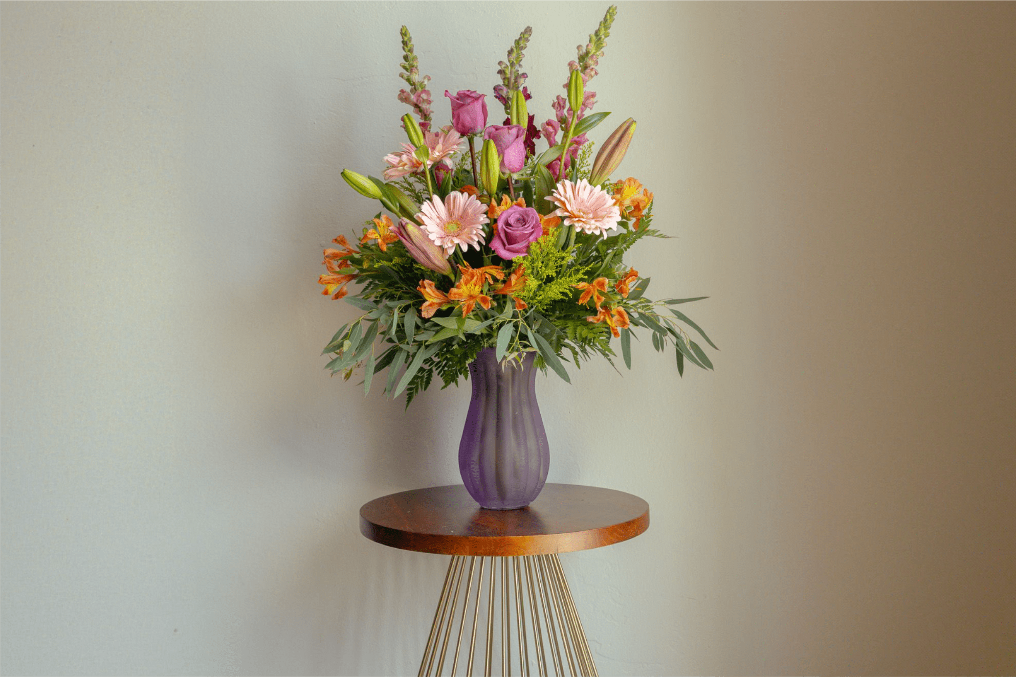 Designer Blooms - Medium Everyday Arrangement  - Mix of season flowers with lush florals which may include roses, spray roses, gerbera daisies, lilies and hydrangeas arranged in a vase. Colors and flowers will be based on the designers choice, selecting the freshest blooms available. 