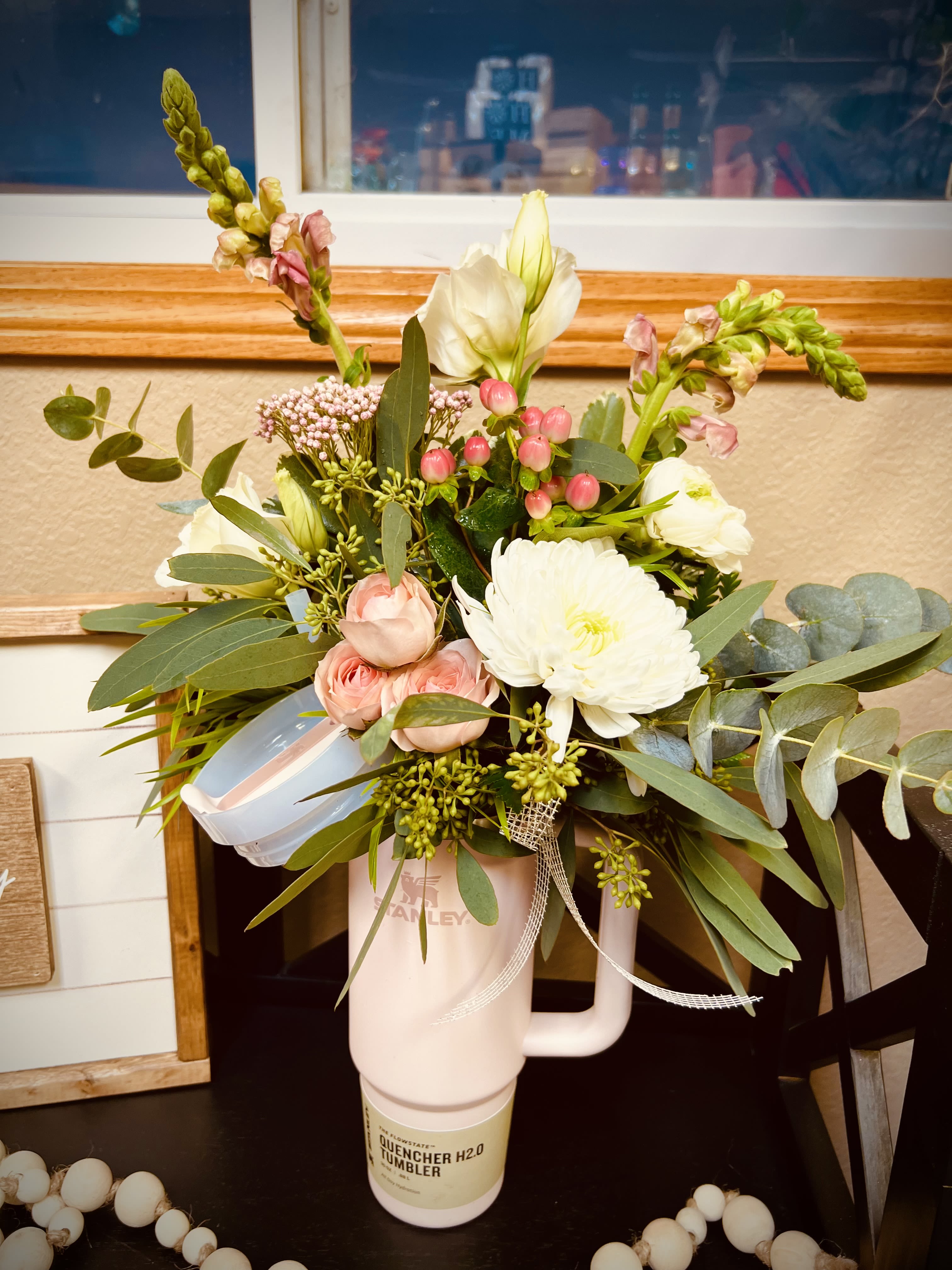 Sip &amp; Bloom Stanley  - Sip in style with a Stanley Bloom Buddy! This fresh mini bouquet is designed to sit perfectly on your tumbler for the cutest grab-and-go gift. Featuring soft blush blooms, creamy whites, fresh greenery, and pops of pink berries—this arrangement is the perfect little pick-me-up for birthdays, Valentine’s Day, thank-yous, or just because.   Includes fresh flowers + greenery arranged as a Stanley topper  Each one is unique based on seasonal blooms