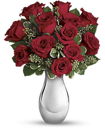 Teleflora's True Romance Bouquet with Red Roses - Turn up the heat on a new romance - or a lifelong love affair - with this premium rose bouquet. It features a total of fifteen of our finest red and hot pink roses and is accented with smaller red spray roses and luxuriant greens. It's all artfully arranged in our stunning Silver Reflections vase. This romantic bouquet includes large red and hot pink roses, bountiful red spray roses and greens including seeded eucalyptus and variegated pittosporum. This bouquet is delivered in our exclusive Silver Reflections vase, a metalized ceramic vase with a light pink tone. 