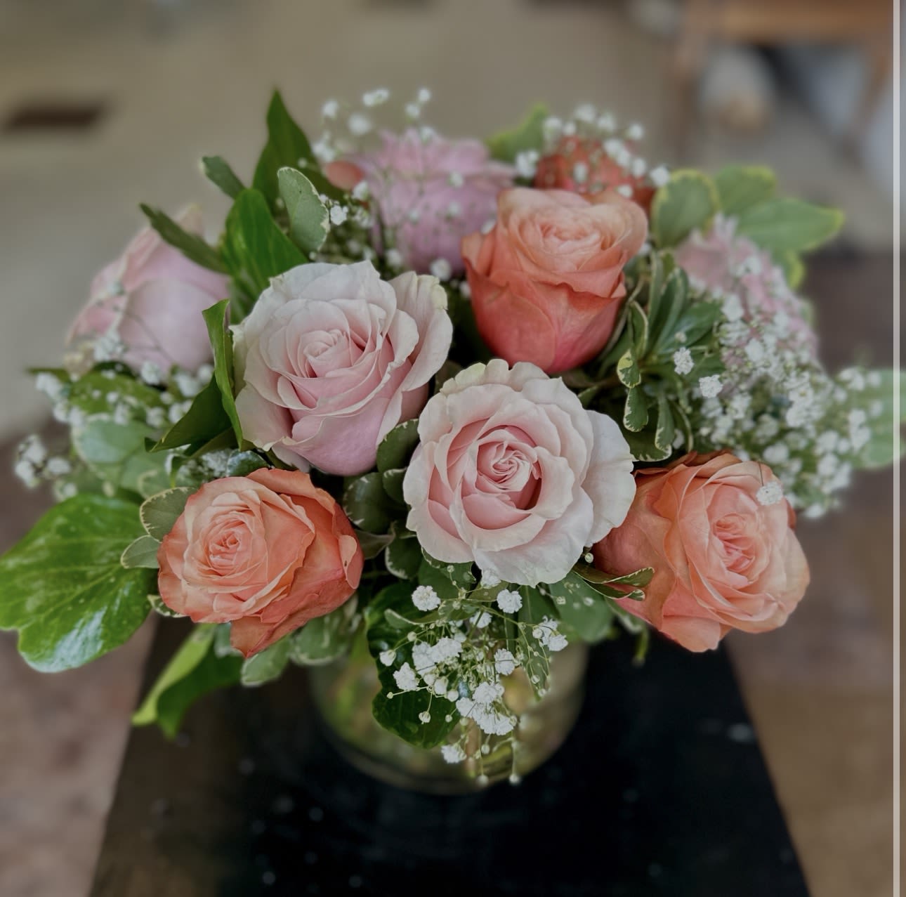Custom Low And Lush Dozen Roses - A modern, low and lush dozen roses, designed in a glass cylinder. Customize your dozen by letting us know what color you’d like in the special requests section. 
