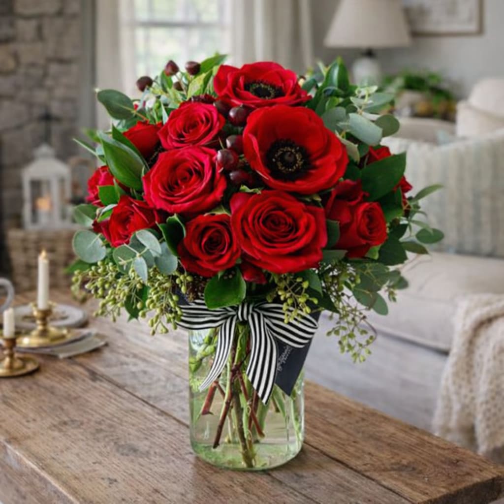 Sweet Sangria  - Sweet Sangria™ Floral Arrangement  Rich, romantic, and irresistibly vibrant, Sweet Sangria™ is a lush floral arrangement inspired by the deep jewel tones of a perfectly poured sangria. Designed to feel warm, celebratory, and indulgent, this bouquet blends saturated reds, berry hues, and soft complementary florals for a look that’s bold yet elegant.  Hand-crafted with premium seasonal blooms—such as roses, spray roses, ranunculus, or accent flowers in sangria reds, wine, plum, and blush—this arrangement delivers dramatic color and full texture from every angle. Finished in a stylish vase, Sweet Sangria™ makes an unforgettable statement for anniversaries, romantic gestures, or just because.  Perfect for gifting or elevating a space, this arrangement feels luxurious without being overpowering—ideal for modern homes, classic interiors, and boutique-style settings.  Why Customers Love It  Rich sangria-inspired color palette  Full, garden-style design with premium blooms  Elegant, gift-ready presentation  Perfect for romance, celebration, and special moments  Great For Romantic occasions • Anniversaries  • Date nights • Thank-you gifts • Just-because flowers