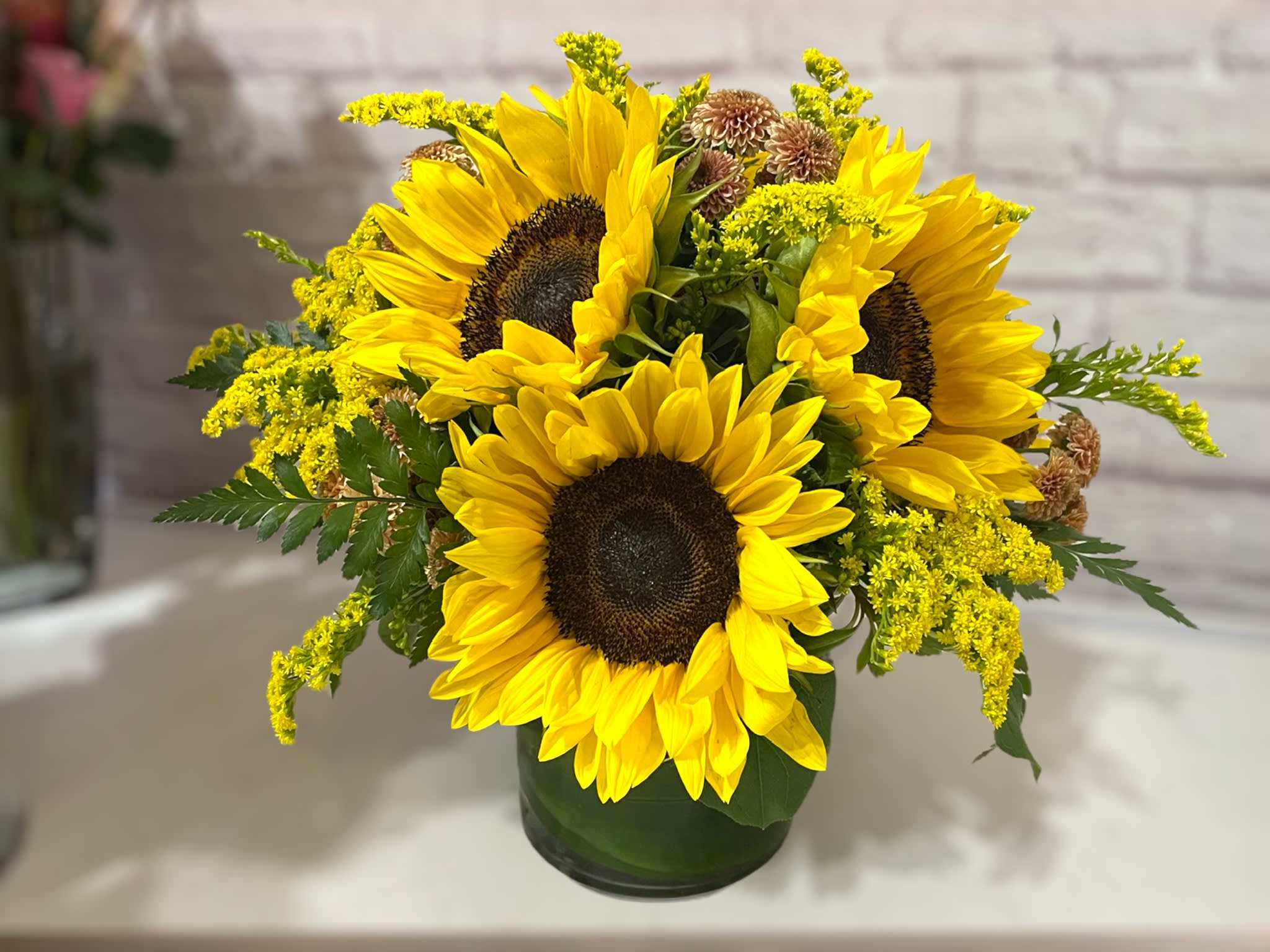 Sunny Sunflowers by BloomNation™ - The sun is pretty great, but sunflowers are the greatest. Let’s prove it. The sun keeps us warm, we’ll admit it, but sunflowers never make us sweat. The sun gives us the daytime, which we appreciate, but sunflowers don’t go away for 12 hours per day day. Sunflowers, unlike the sun, know that would be rude. Finally, the sun gives us a nice tan once in awhile, but sunflowers have never given anyone a sunburn. This autumn, let sunflowers enhance your life, or the life of a loved one, with this Sunny Sunflower arrangement! You will not regret it.