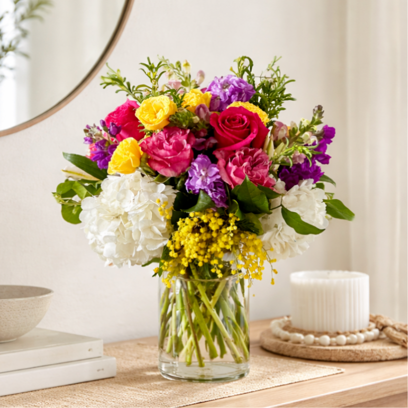 Just The Way You Are  - Show the special someone how much you appreciate Just the way the are with this arrangement. A colorful mix of roses, spray roses, hydrangea and other seasonal flowers in a clear glass vase. Perfect for all occasions. 