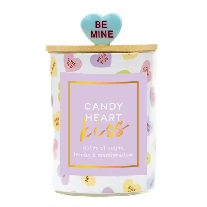 Candy Heart Kiss Candle - • Seasonal Candle Collection • Single-wick, printed glass jar with wooden lid and charm  • 10oz. Paraffin Wax • Burn Time: 50 hours • Dimensions: 3.5"W x 4"H • Fragrance: sugar, lemon &amp; marshmallow  Best Valentine's Day Gift